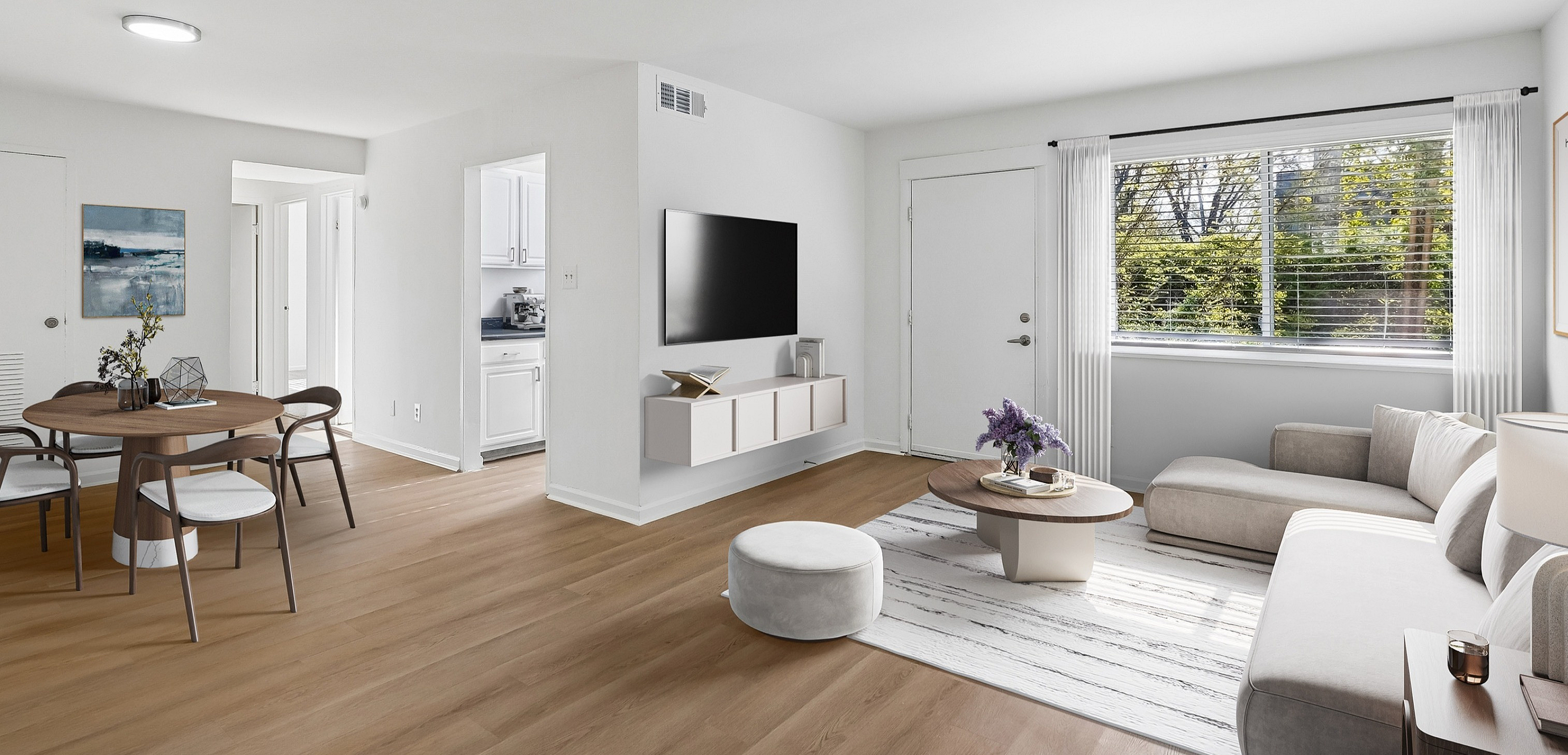 Bright and inviting living room featuring a modern sectional sofa, sleek wall-mounted TV, and elegant dining area with stylish chairs, complementing the natural light from large windows.