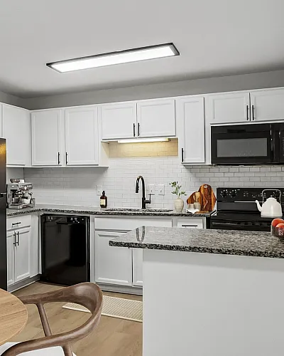 Modern open-concept kitchen and dining area with elegant cabinetry, sleek appliances, and inviting natural light.