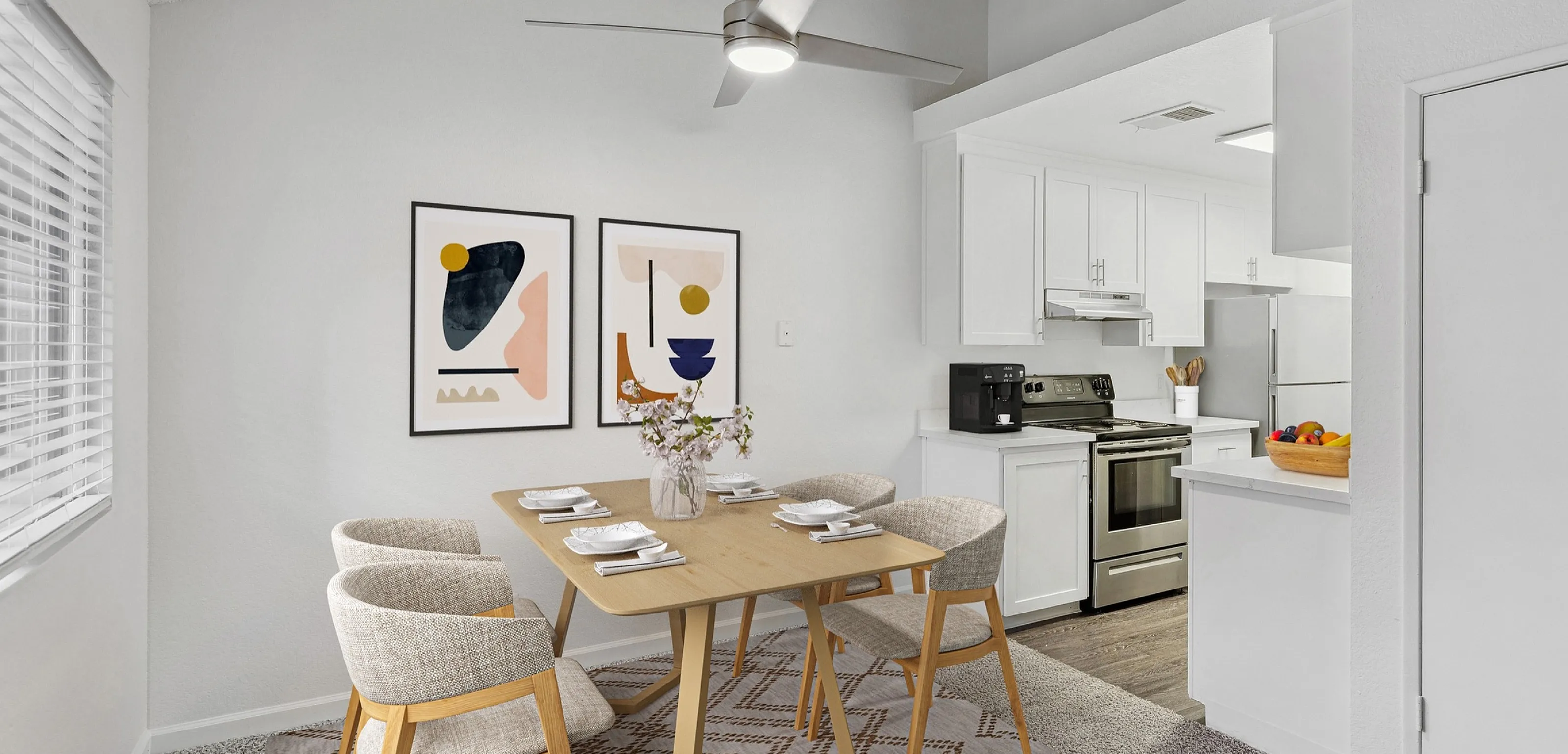 Elegant dining area with modern art decor and open kitchen design, featuring sleek stainless steel appliances and natural lighting.