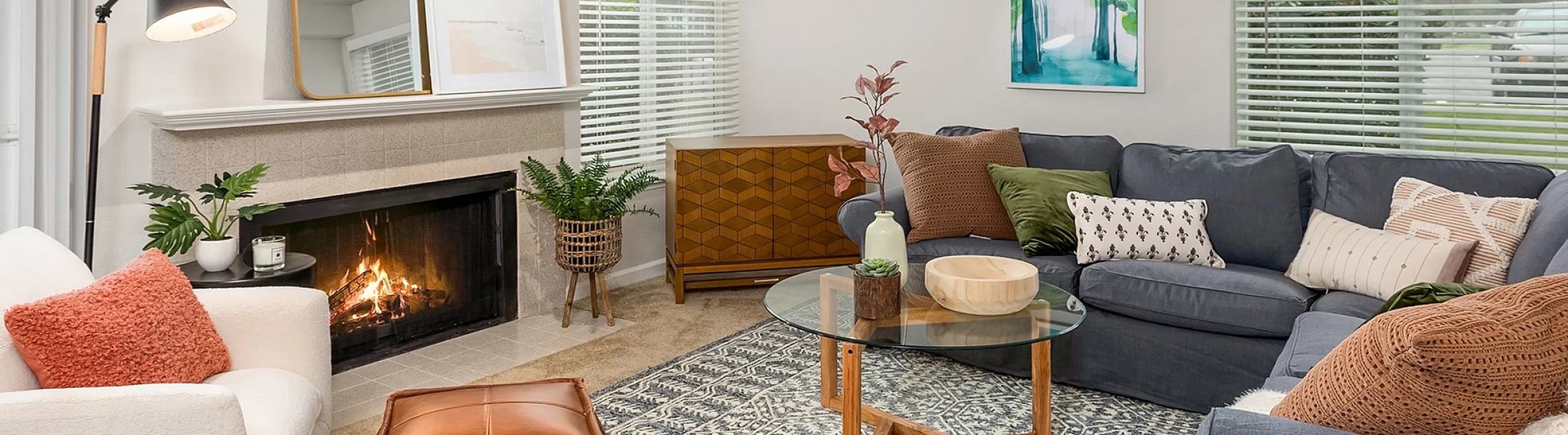 Cozy and modern living room with a warm fireplace, stylish decor, and a plush sectional sofa. Ideal for relaxation and entertaining.