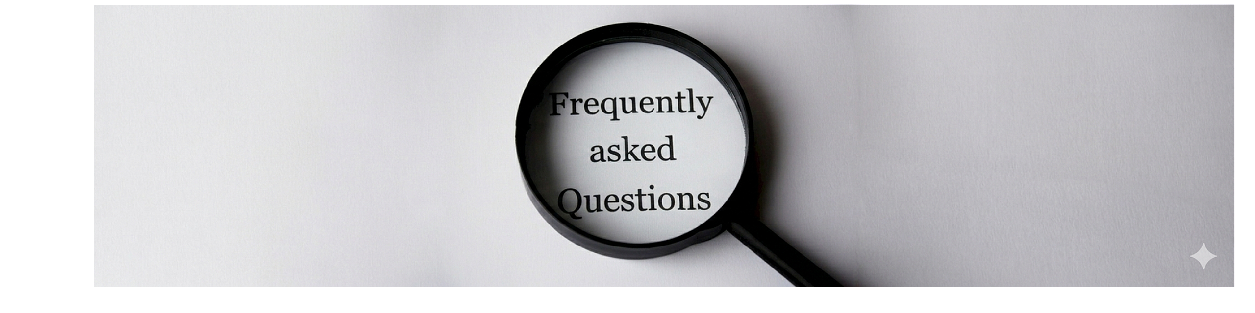 Magnifying glass highlighting 'Frequently Asked Questions' on a crisp white background, creating an inviting and informative atmosphere.