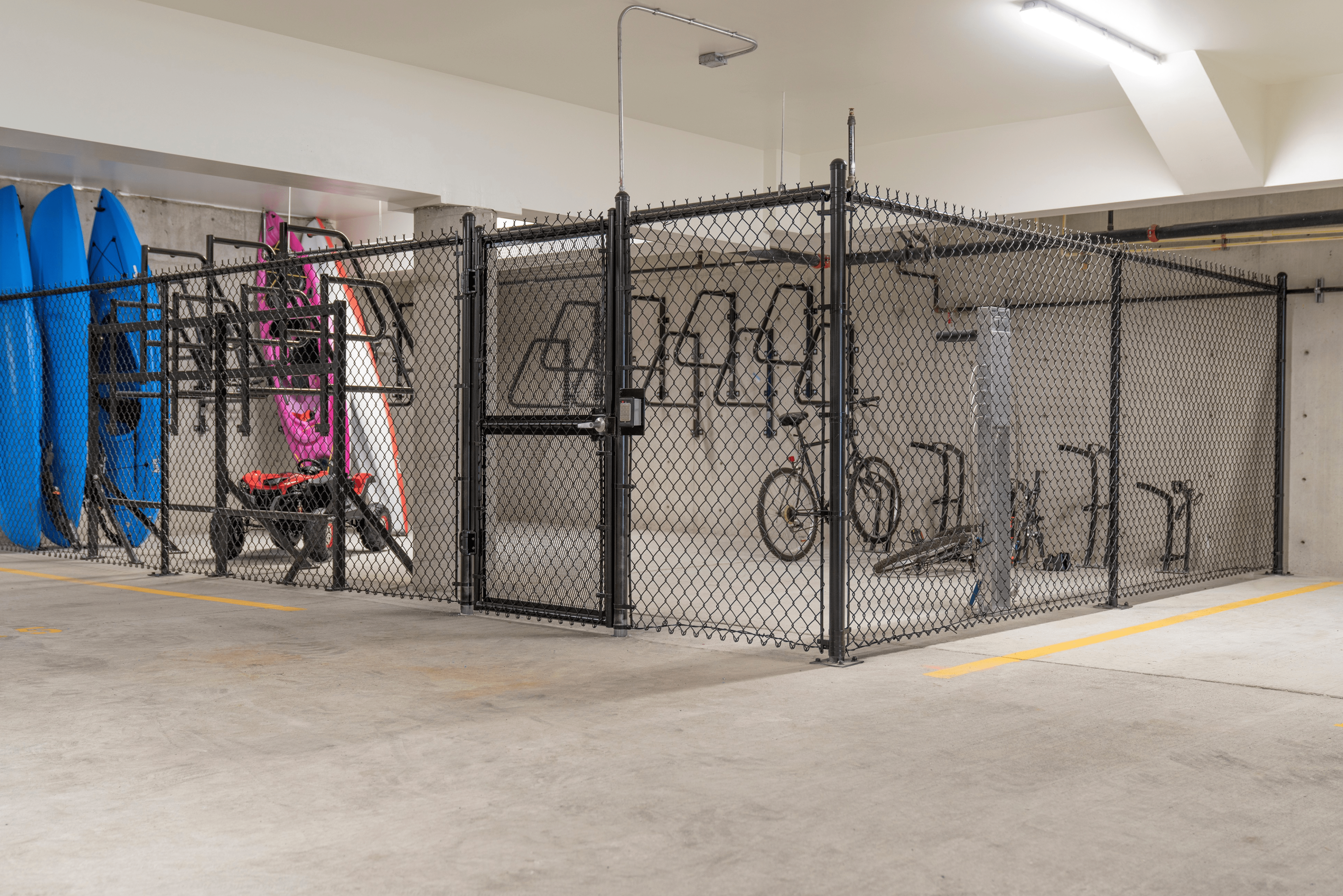 Secure apartment storage featuring bike racks and vibrant kayaks, ideal for outdoor enthusiasts.