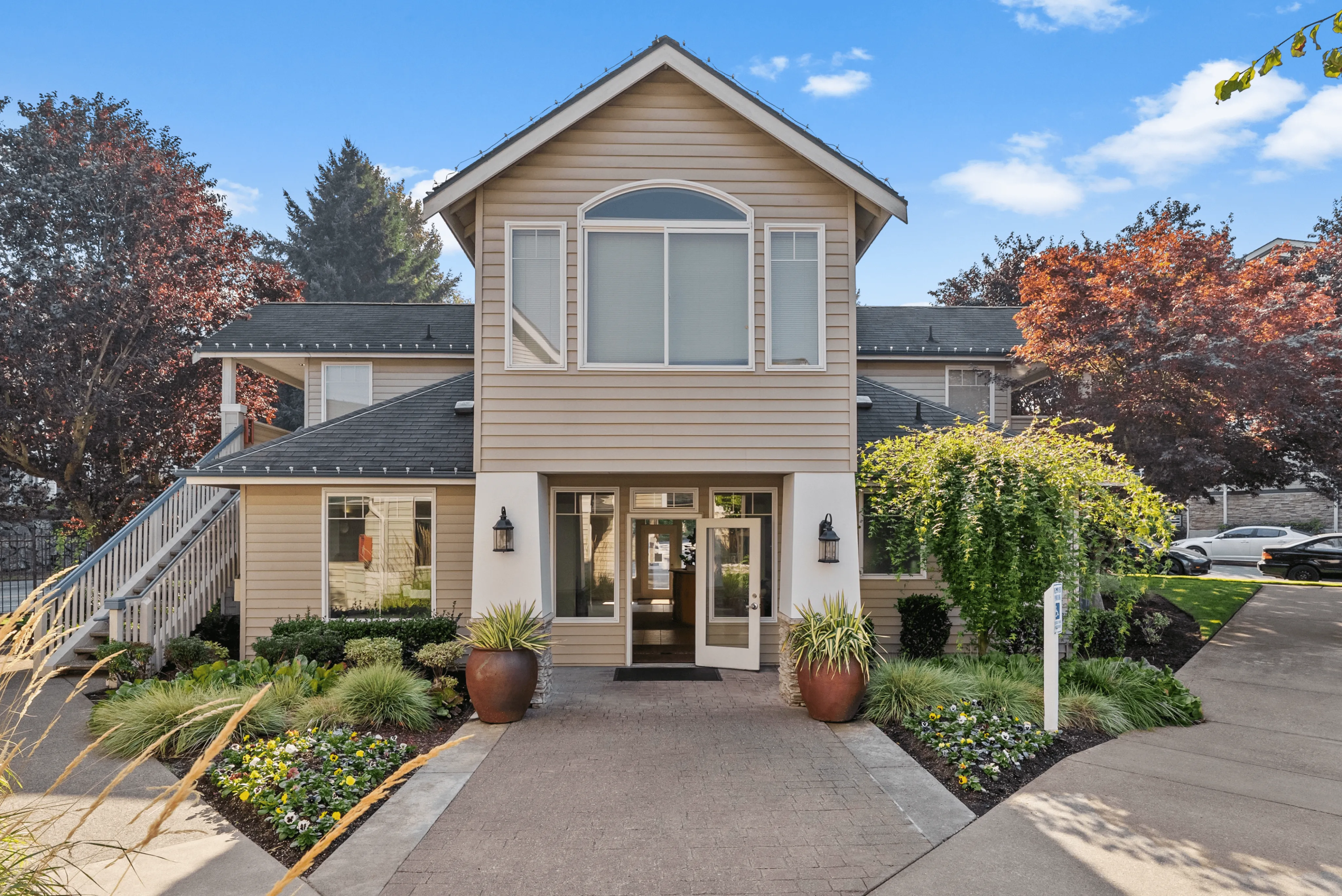 Charming apartment exterior with lush landscaping, inviting entrance, and picturesque surroundings.