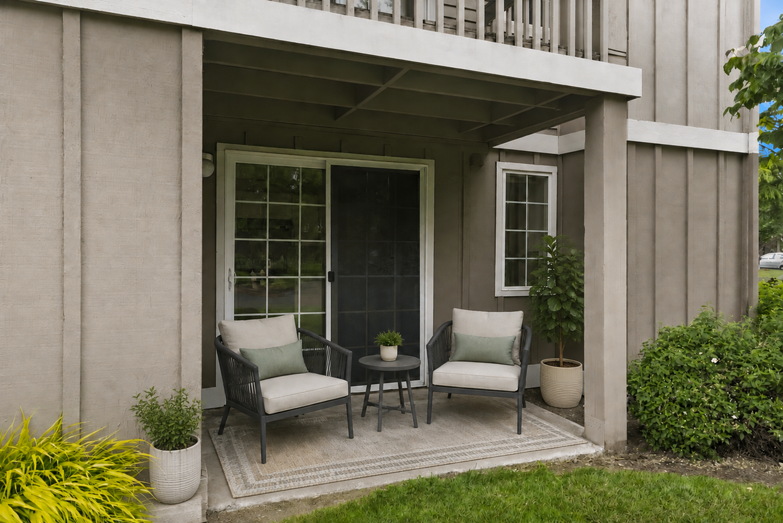Charming patio space with cozy seating and lush greenery, perfect for relaxing outdoors.