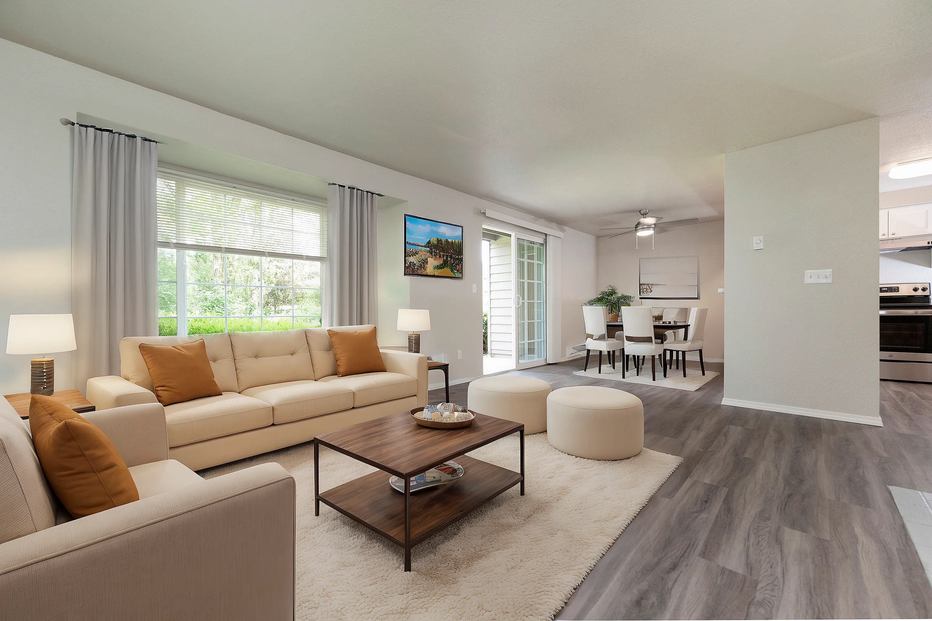 Inviting open floor plan with a cozy living room and elegant dining area in modern apartment.