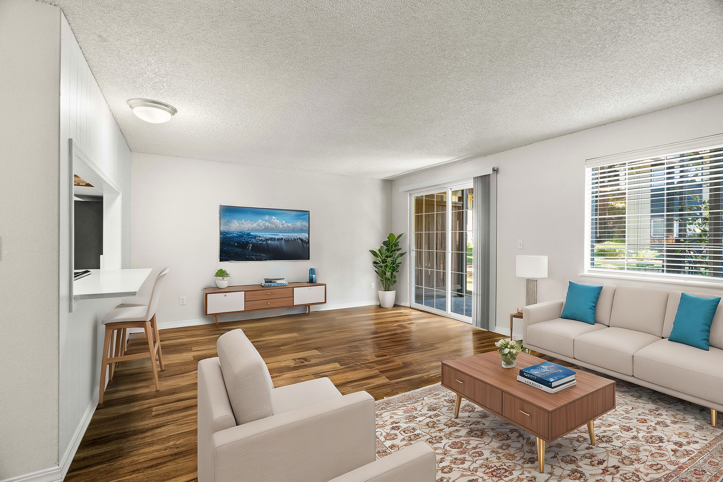 Spacious modern living room with hardwood floors, large windows, and sleek furniture.