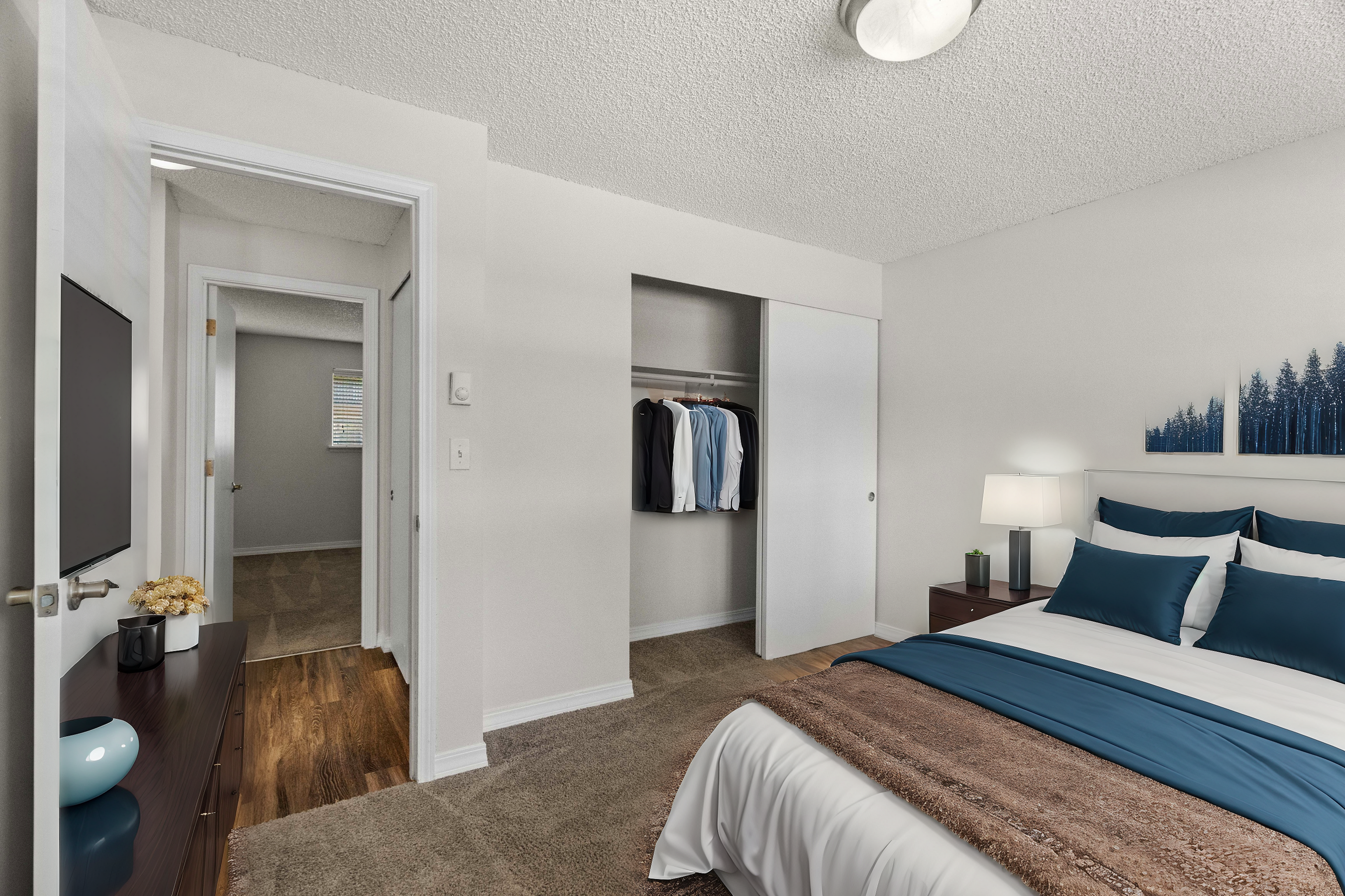 Inviting bedroom featuring soft carpet, modern decor, and a spacious closet.