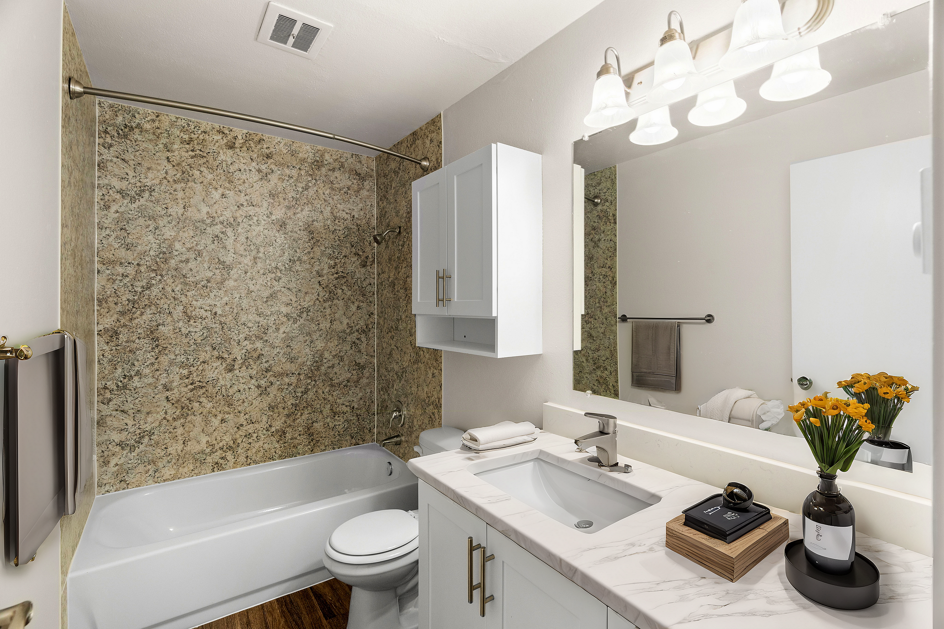 Modern bathroom featuring a luxurious marble countertop, under-mount sink, and decorative lighting.