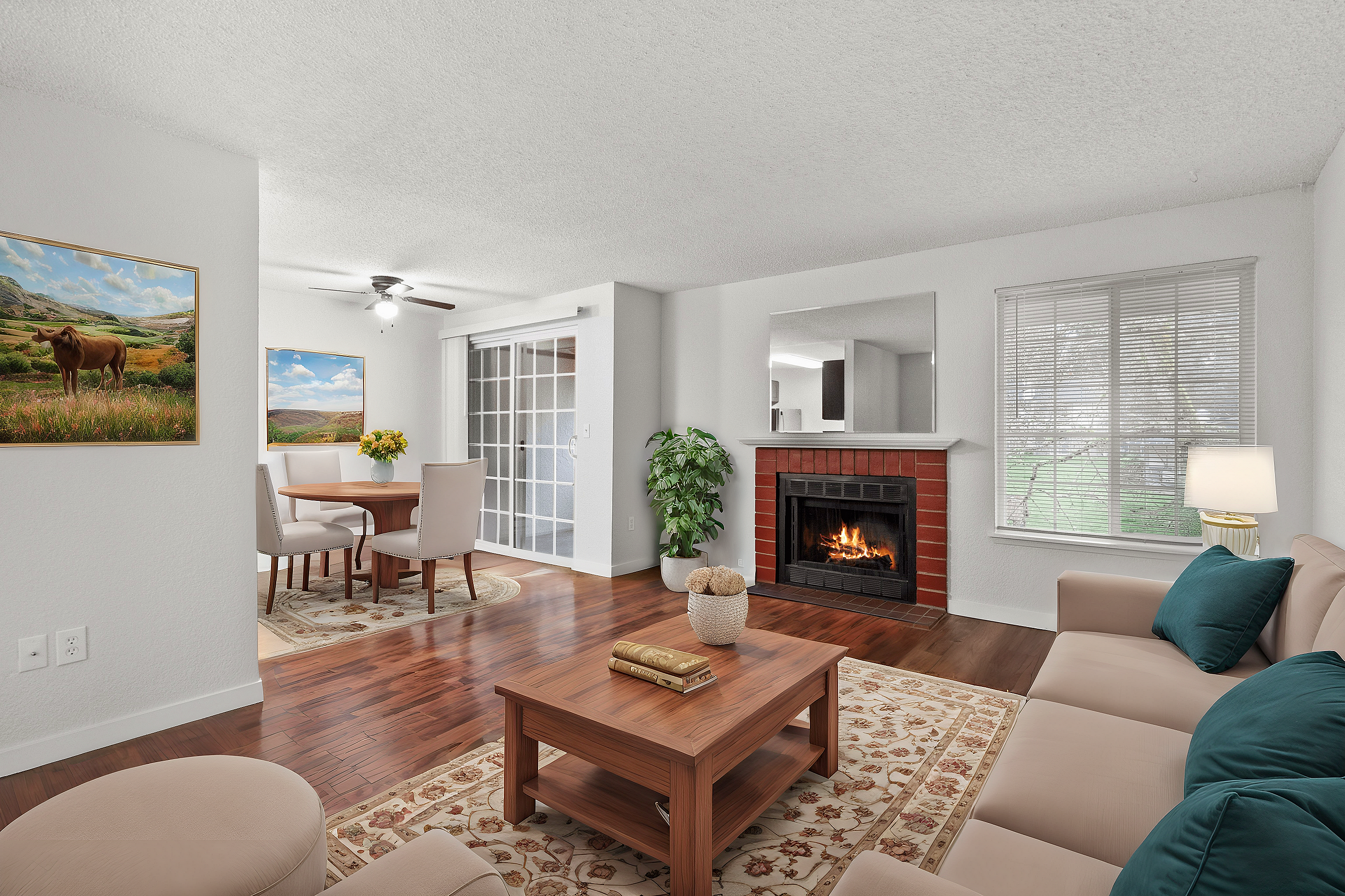 Inviting living room with a warm fireplace, elegant seating arrangement, and a dining area.