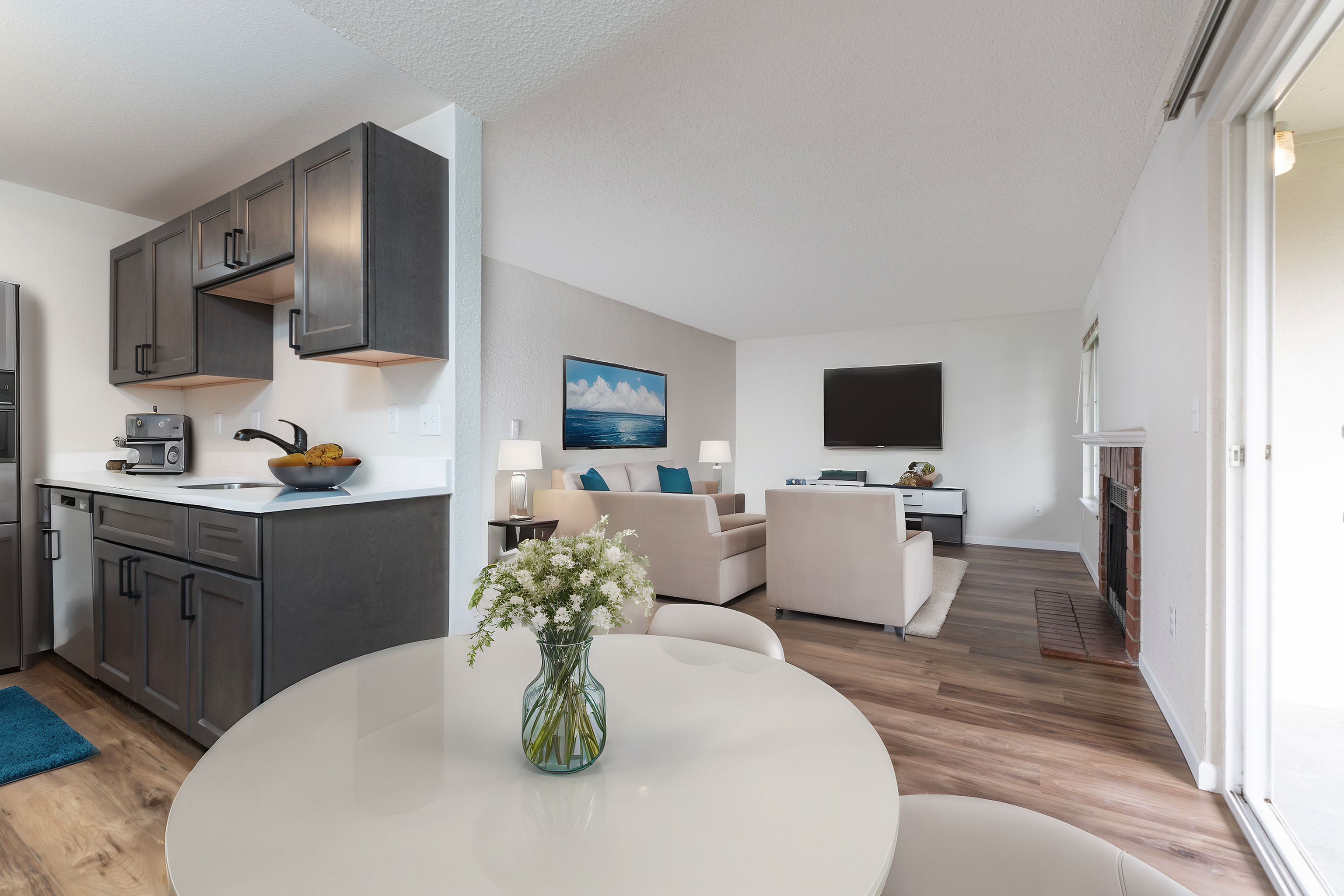 Bright open-plan apartment featuring a modern kitchen, cozy living room, and stylish dining area.