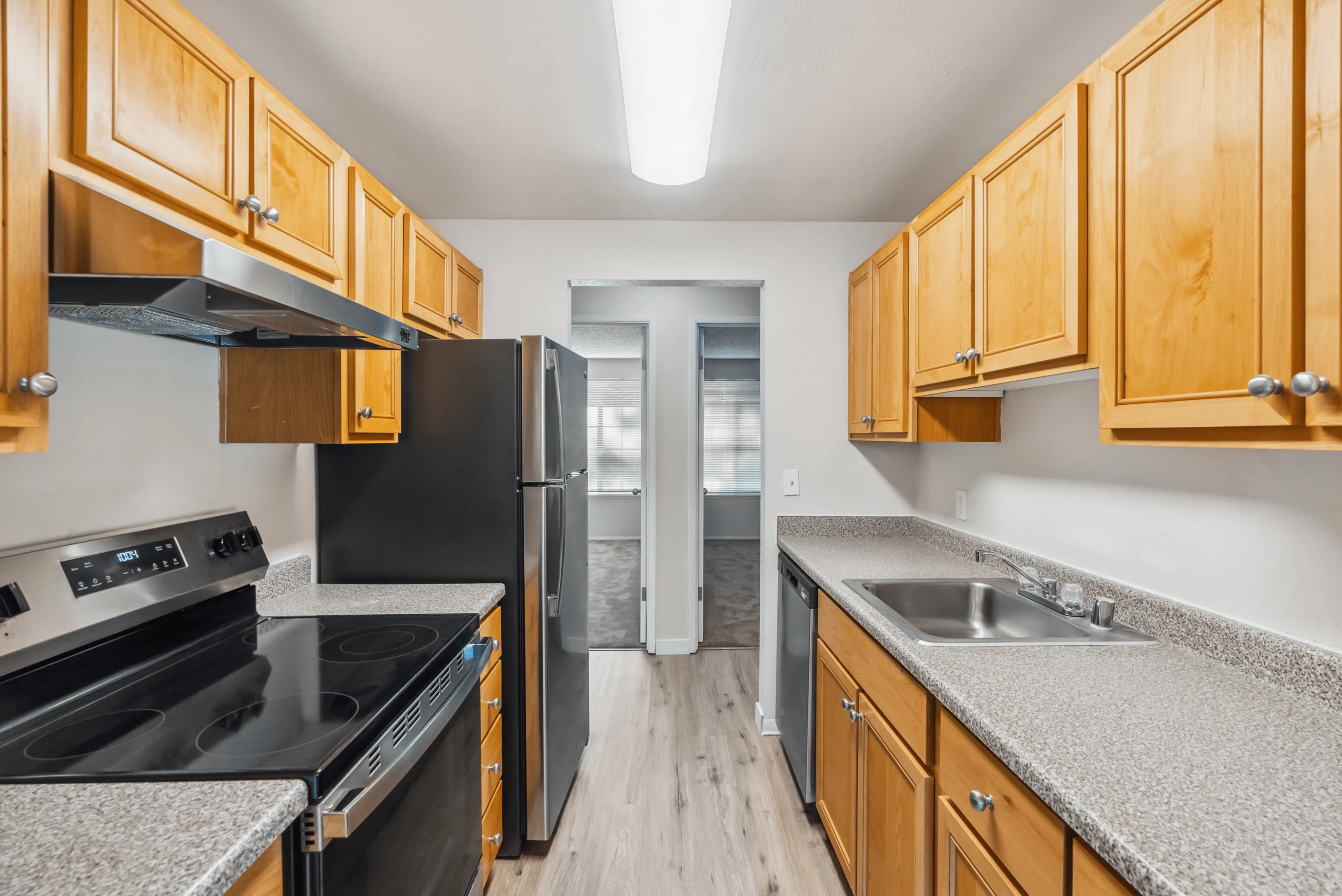 Modern kitchen with wooden cabinets, stainless steel appliances, and ample counter space.
