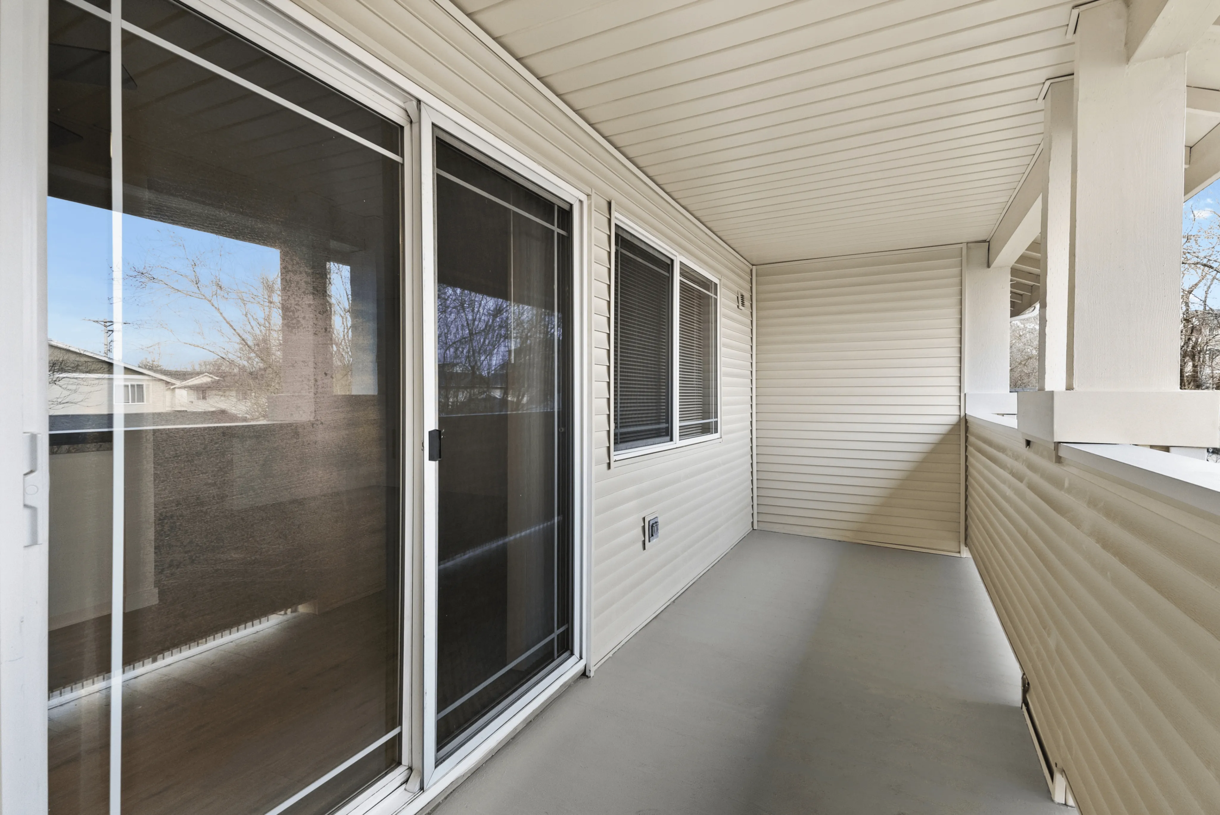 Inviting balcony with sliding glass doors and a serene view, perfect for relaxation.