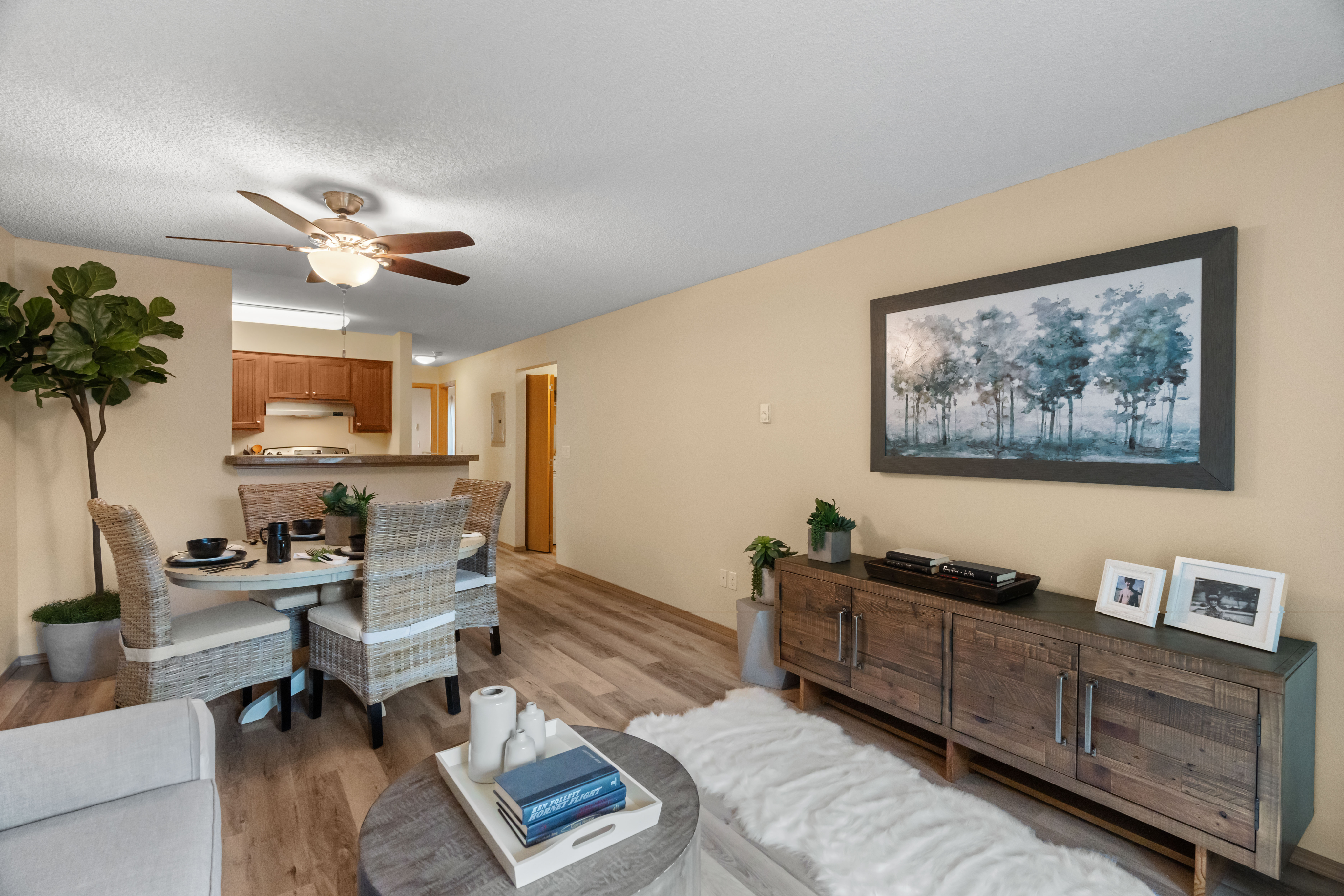 Inviting living space with contemporary decor, featuring a dining area and a stylish kitchen backdrop.