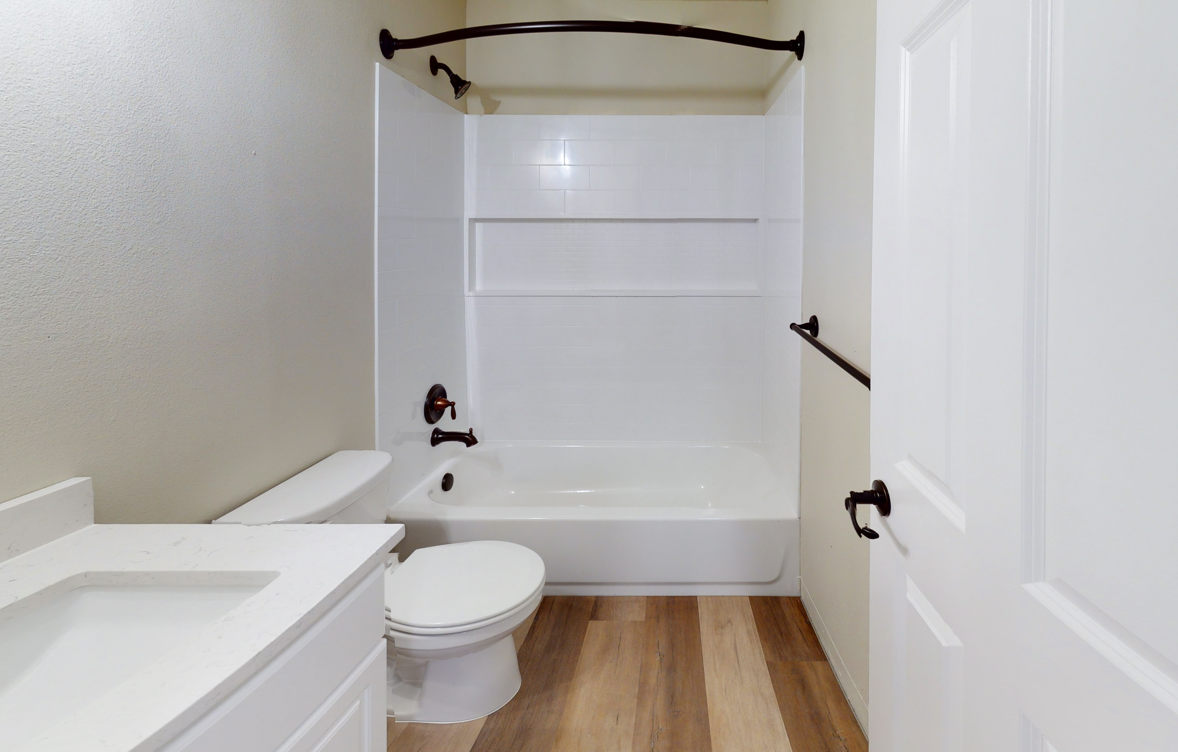 Spacious bathroom with a sleek shower-tub combo and modern fixtures.