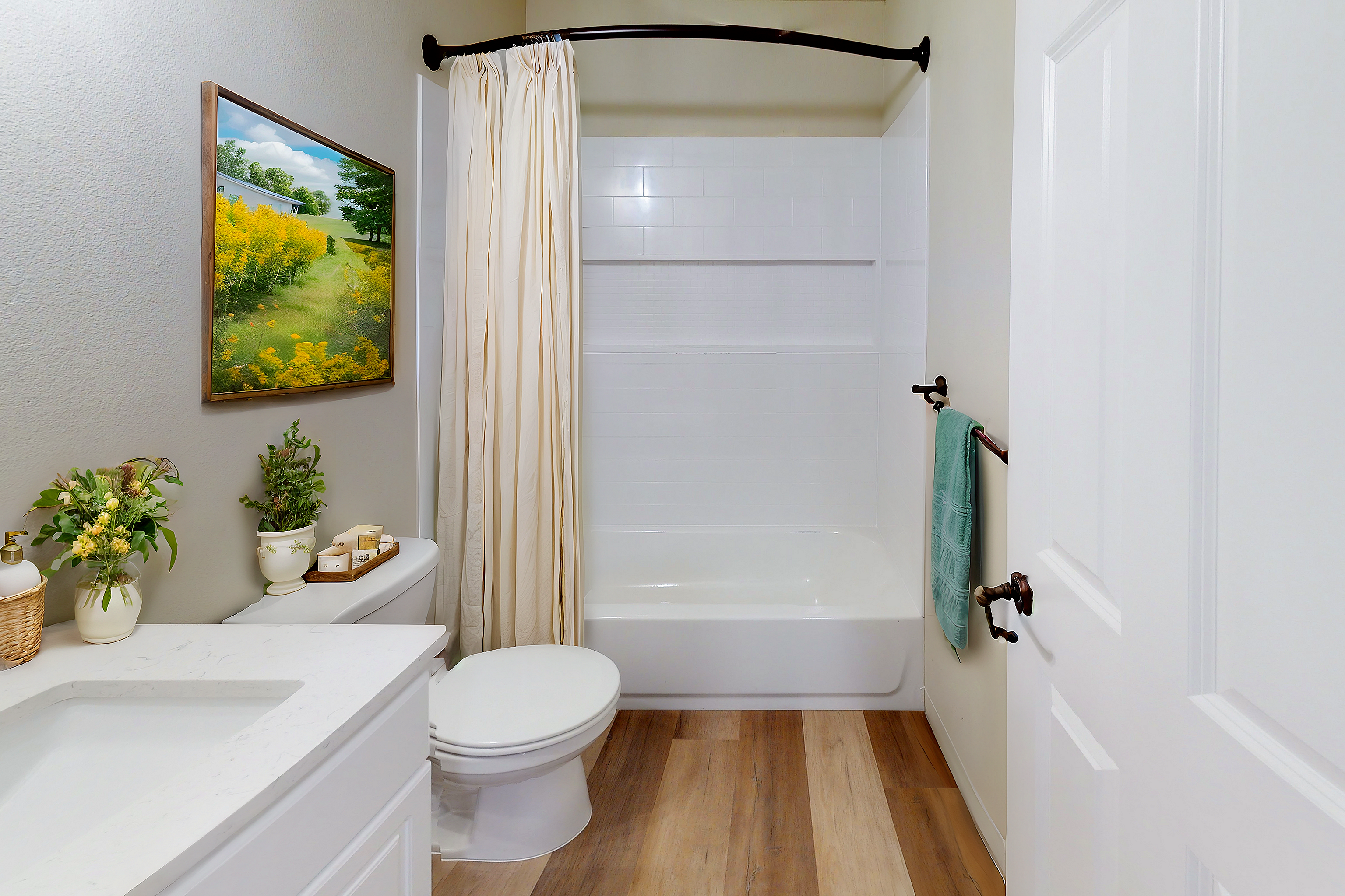 Elegant bathroom featuring a modern bathtub, vibrant wall art, and stylish decor elements.