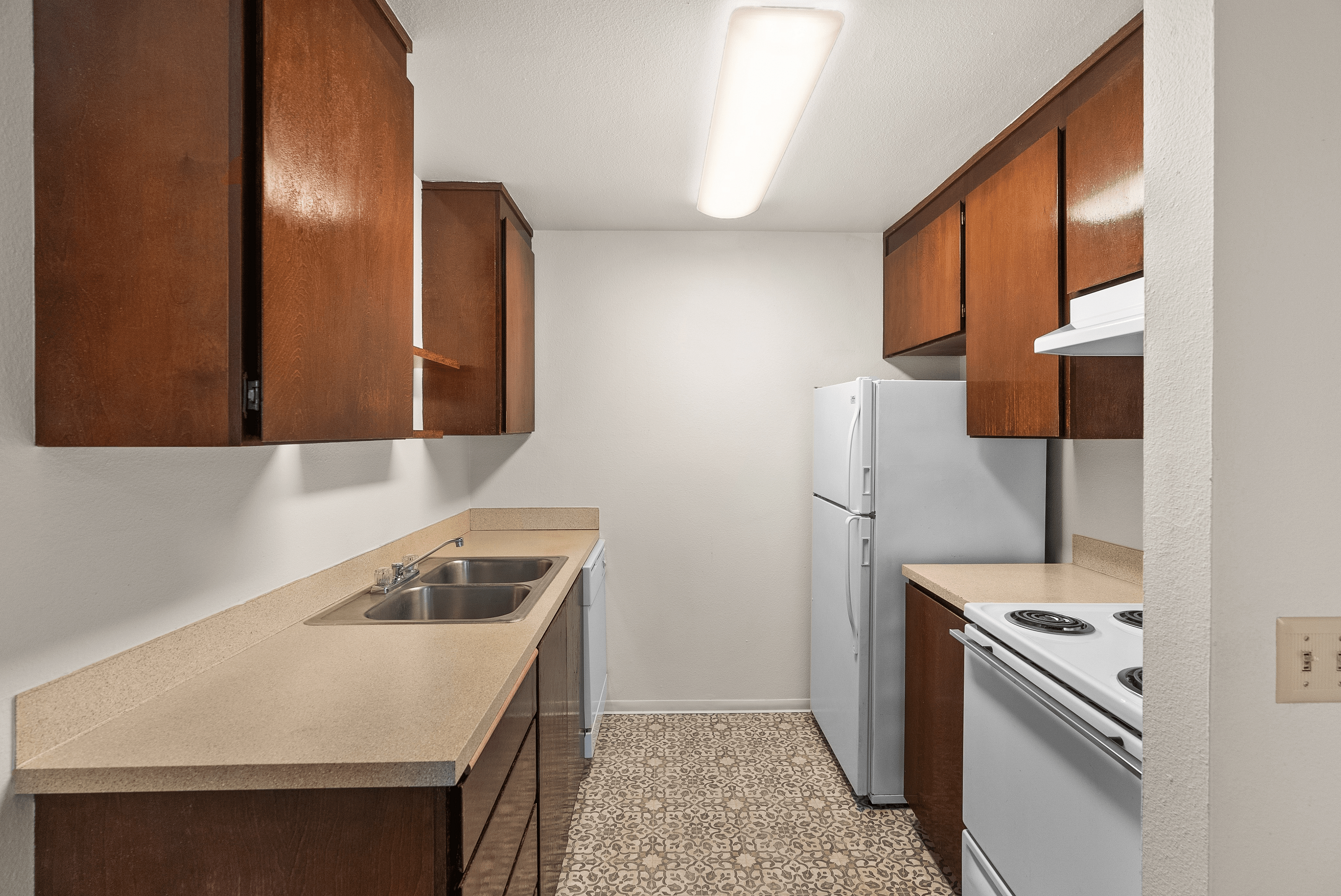 Modern kitchen featuring sleek wooden cabinets, a spacious countertop, and contemporary appliances.