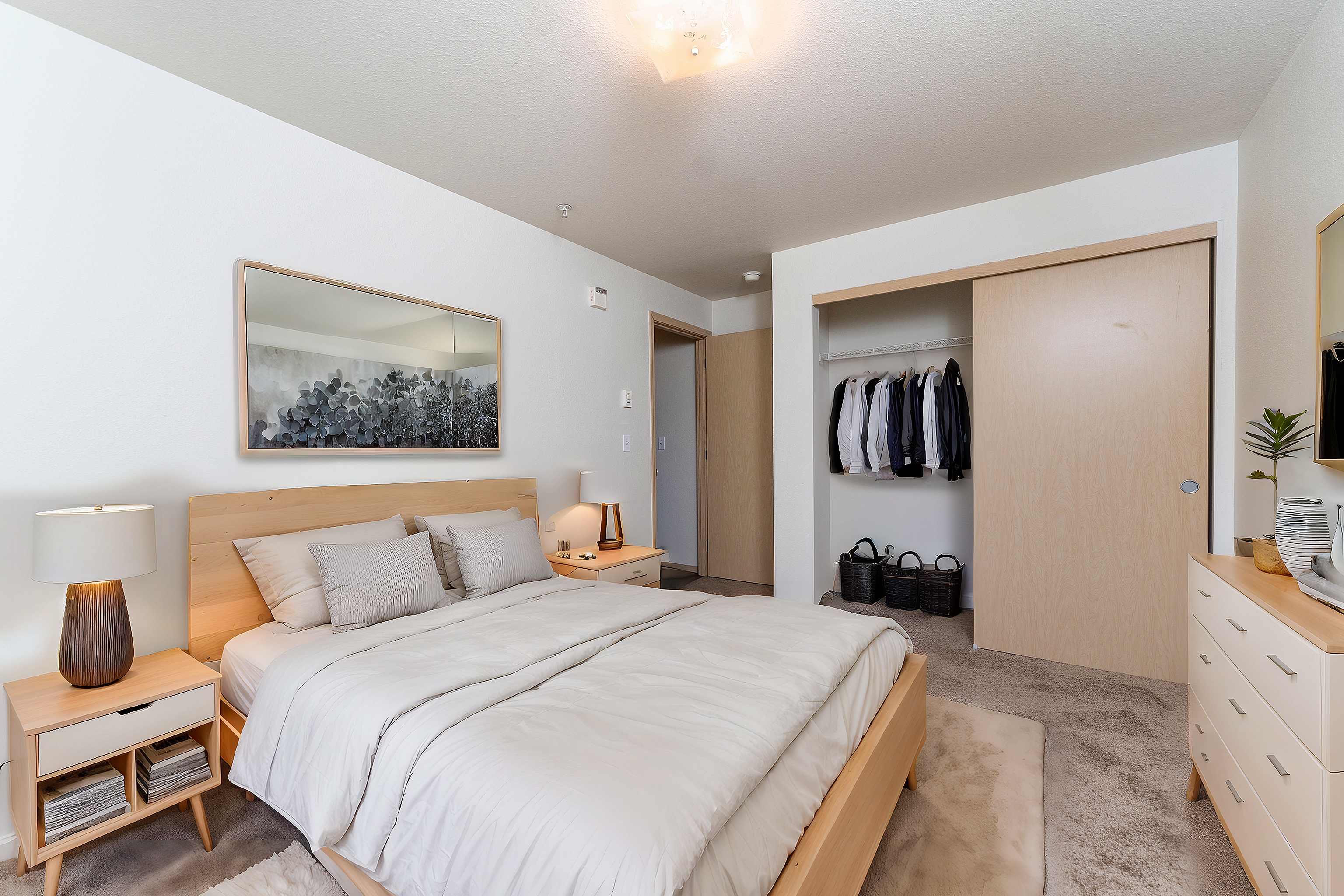 Contemporary bedroom with elegant wooden furniture, soft lighting, and spacious closet showcasing modern design.