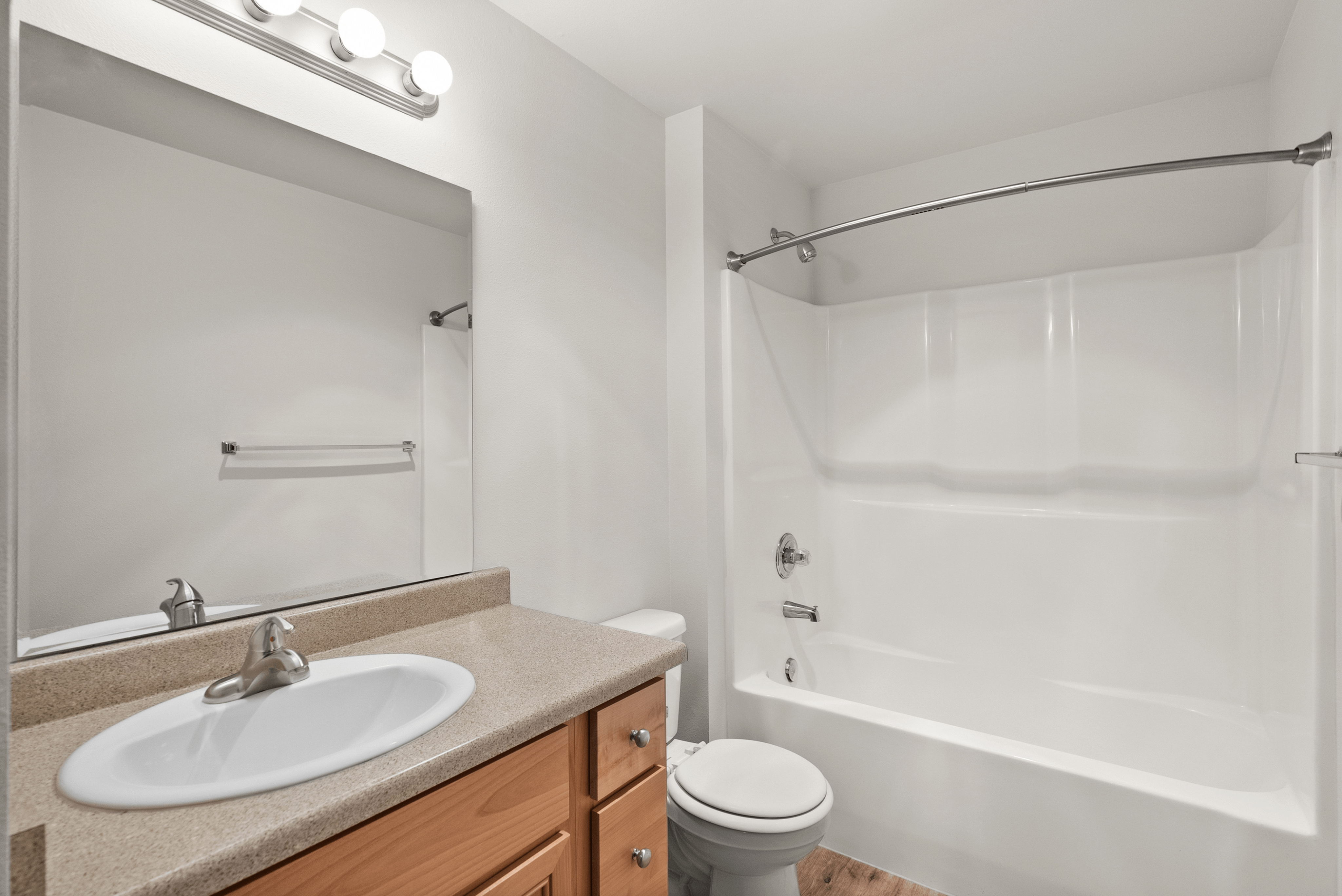 Elegant bathroom featuring a modern vanity, stylish lighting, and sleek bathtub for a tranquil retreat.