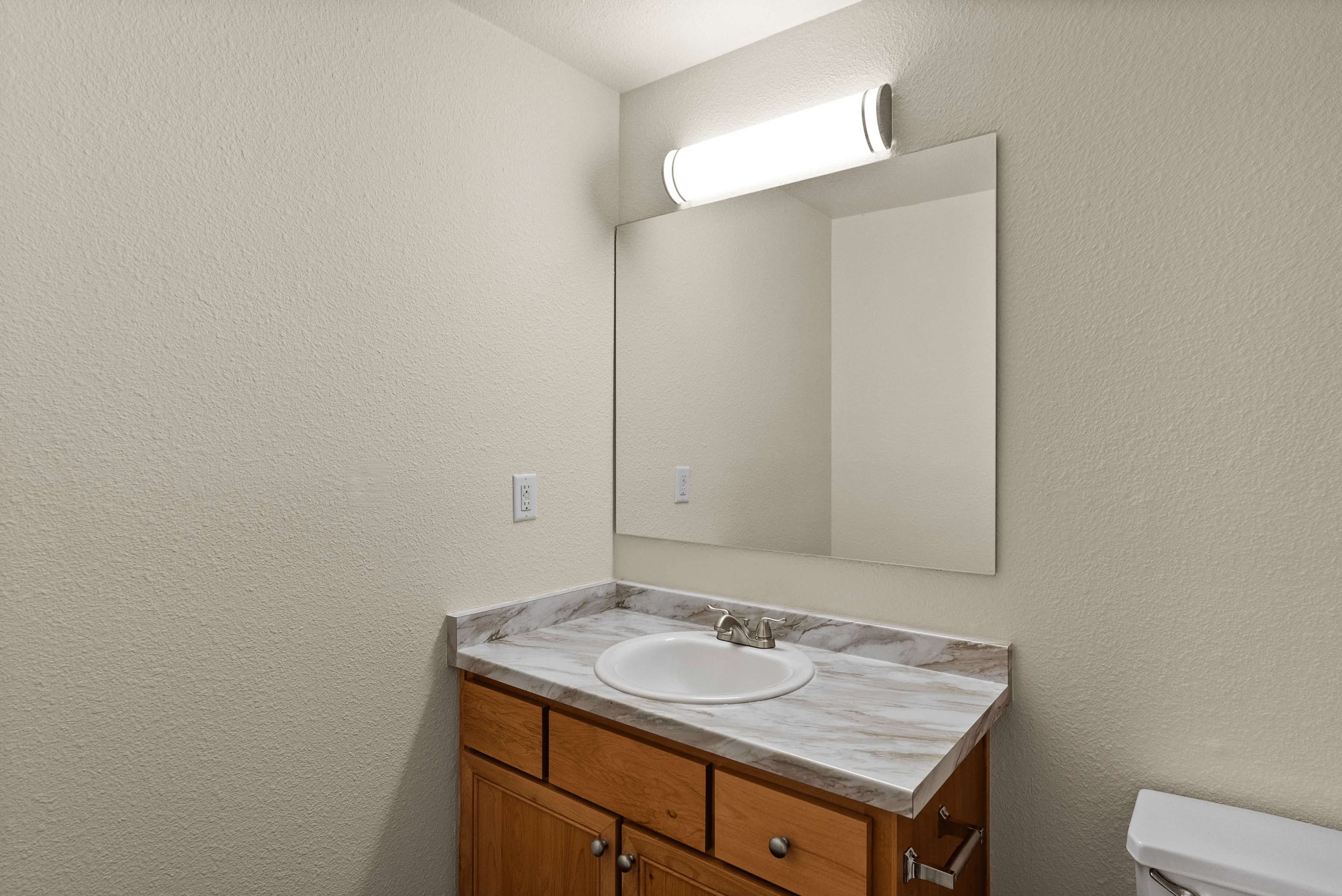 Modern bathroom vanity with sleek lighting and elegant marble countertop.