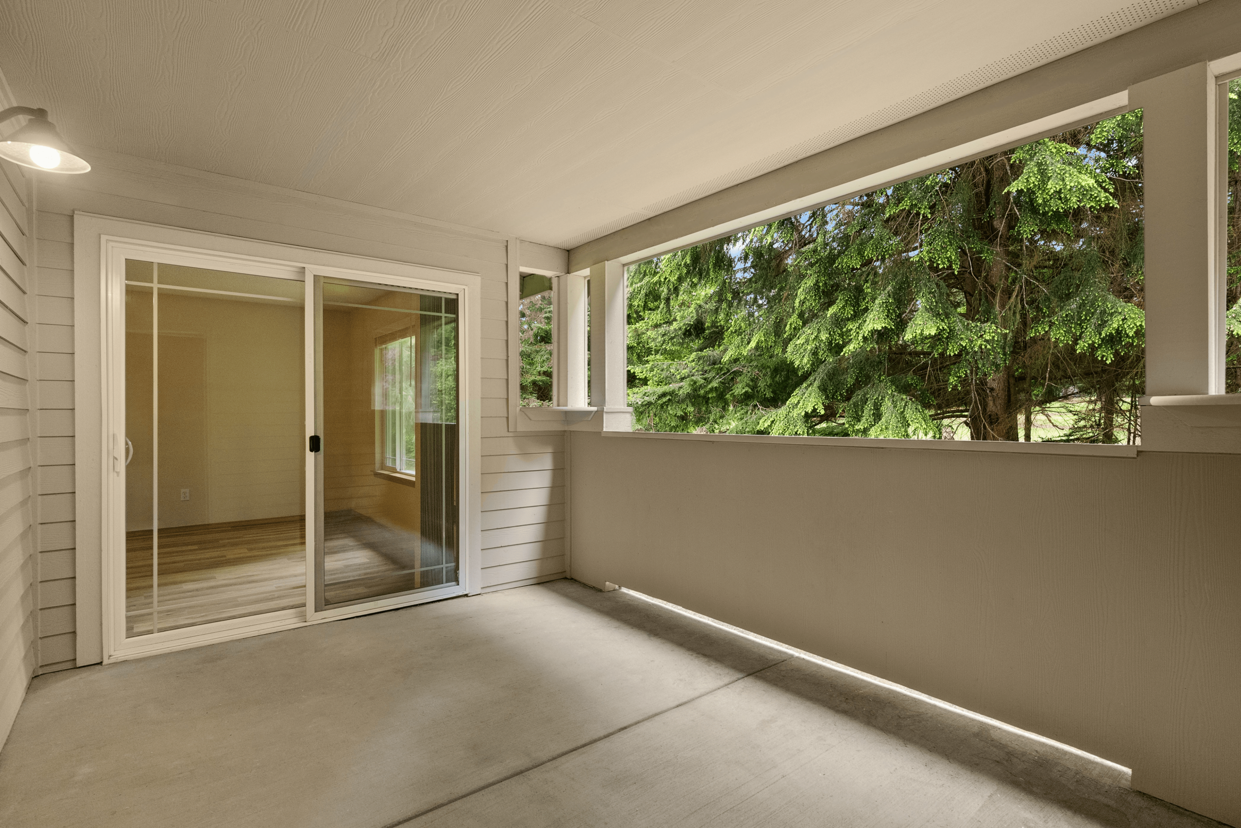 Private covered patio with serene woodland views, perfect for relaxing or entertaining.