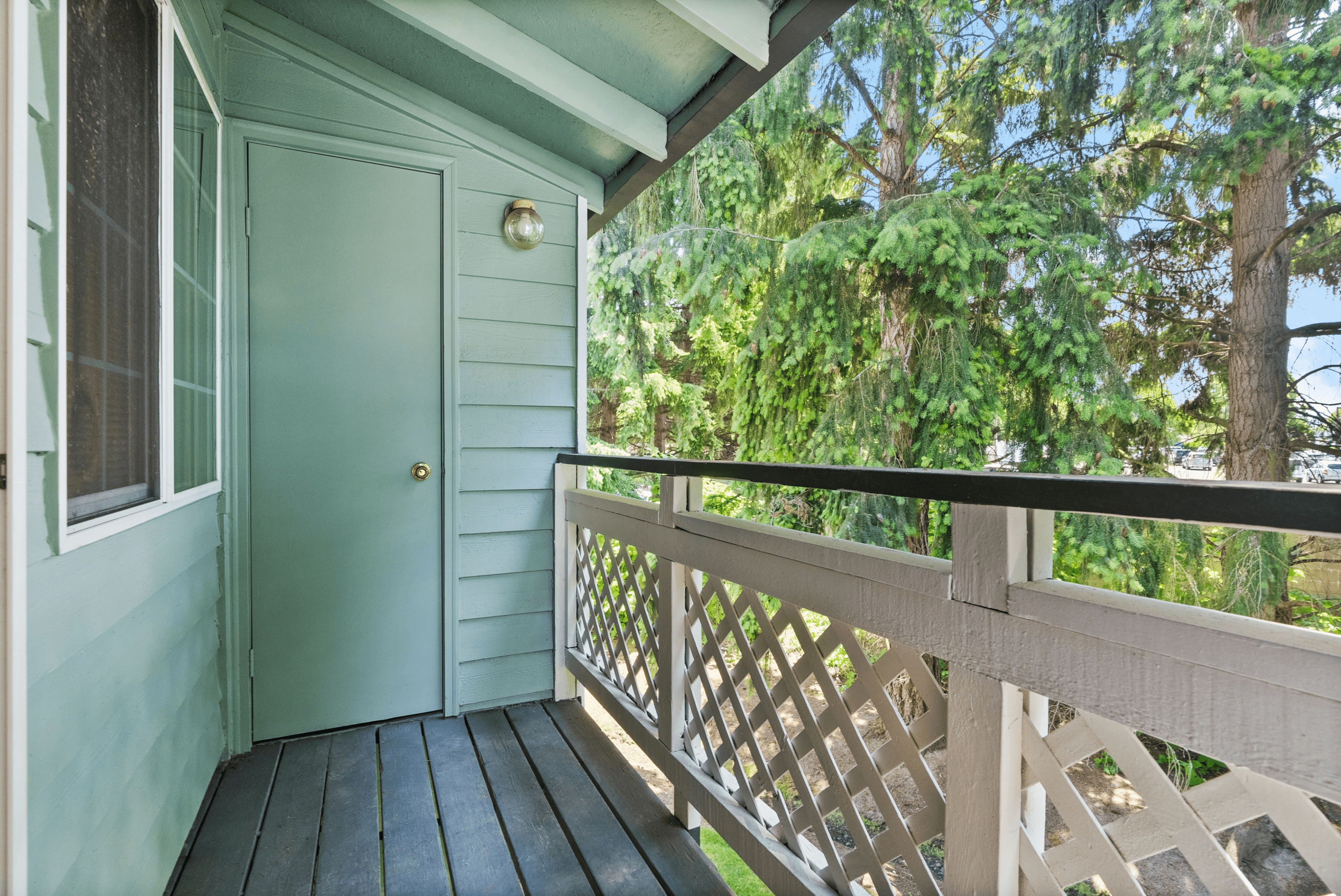Apartment balcony with views overlooking the greenery surrounding the apartment community.