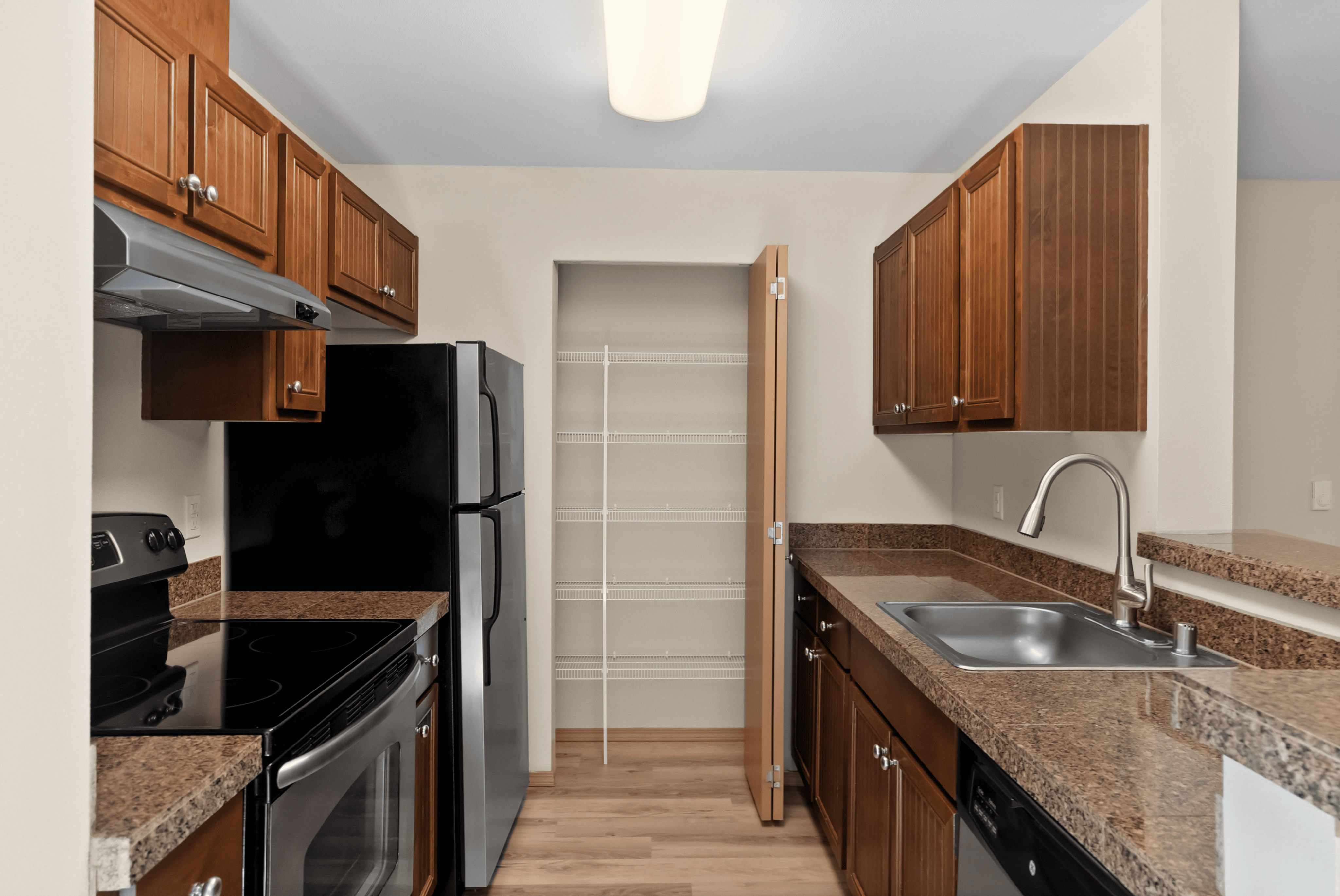 Chic kitchen with modern stainless steel appliances, elegant granite countertops, and ample cabinetry.