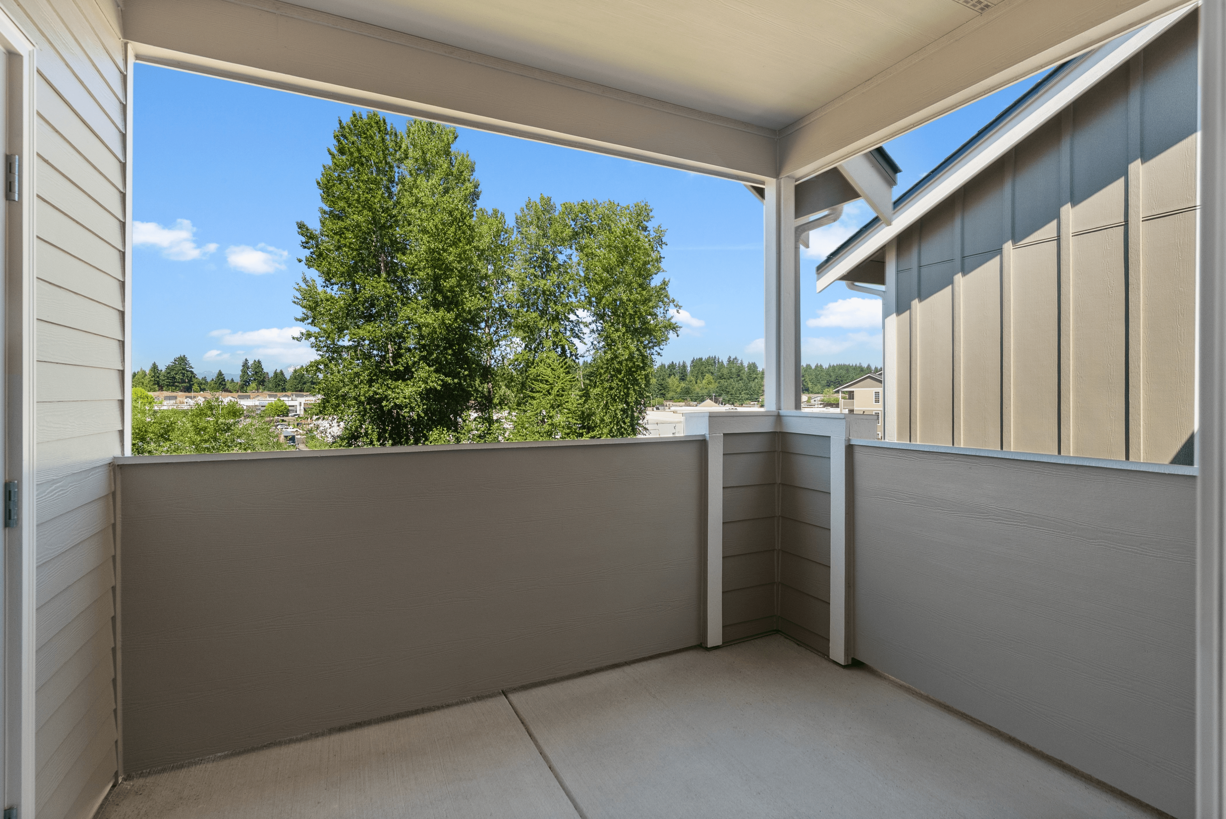 Charming apartment balcony with scenic green views and spacious design.
