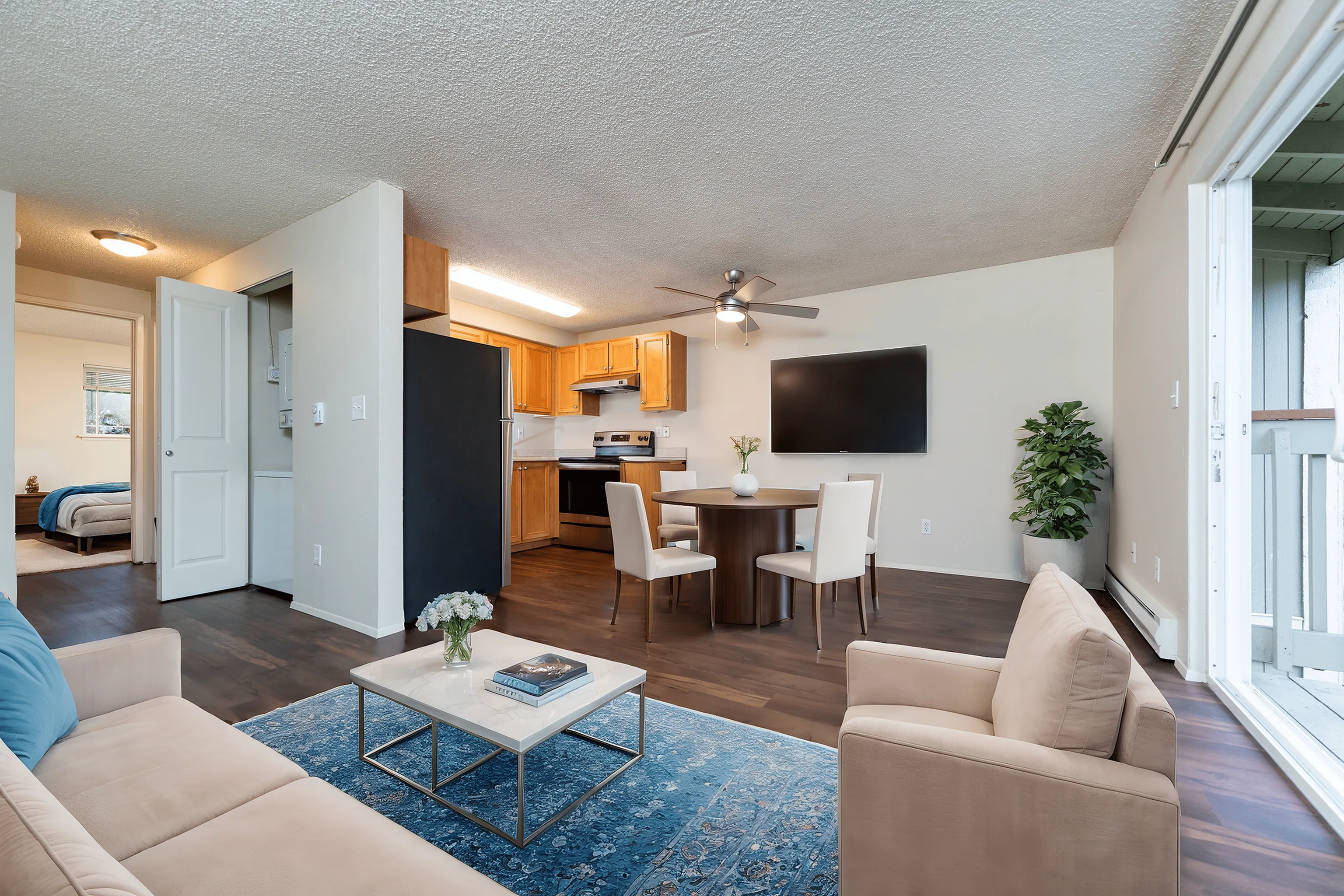 Inviting open-concept living area with modern kitchen, cozy seating, and dining space, featuring elegant decor and natural light.