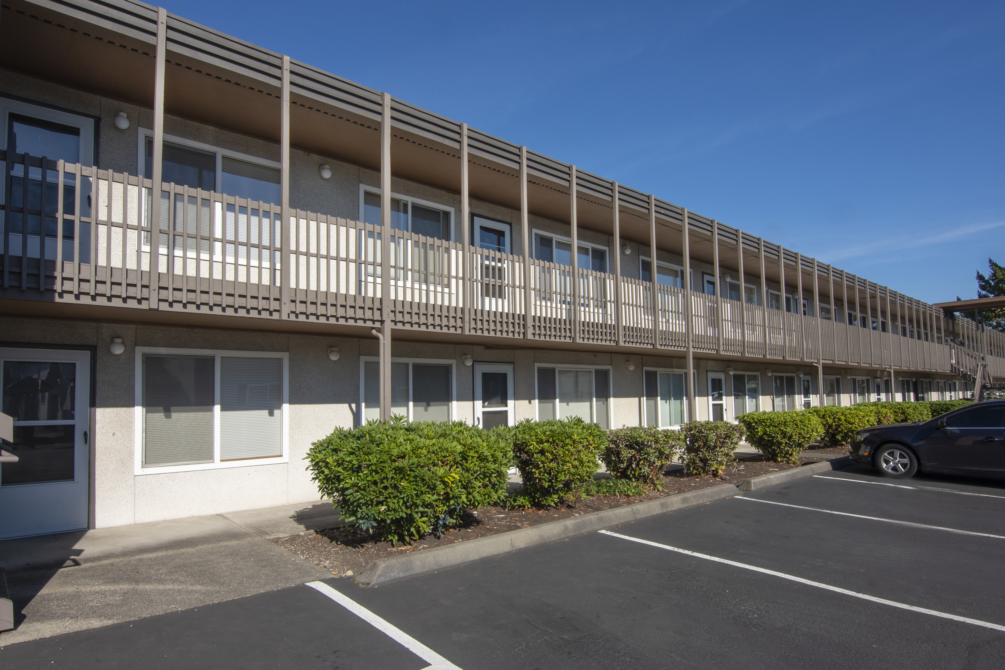 Charming apartment building with contemporary design, featuring spacious balconies and well-maintained landscaping, perfect for modern living.