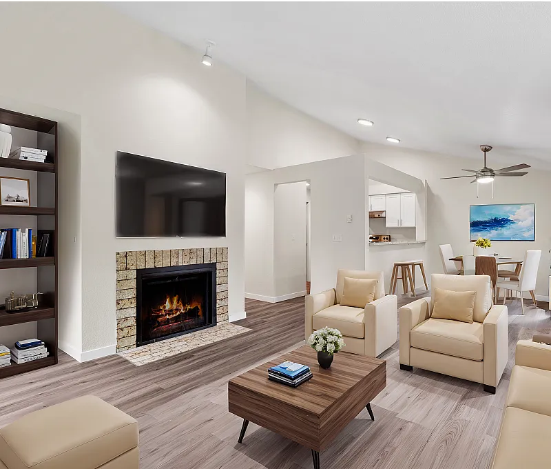 Elegant living room featuring beige leather sofas, a modern fireplace, wall-mounted TV, and open-concept layout with a view into the dining area.