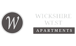 Wickshire West Apartments logo with elegant typography and a circular emblem featuring a stylized 'W'.