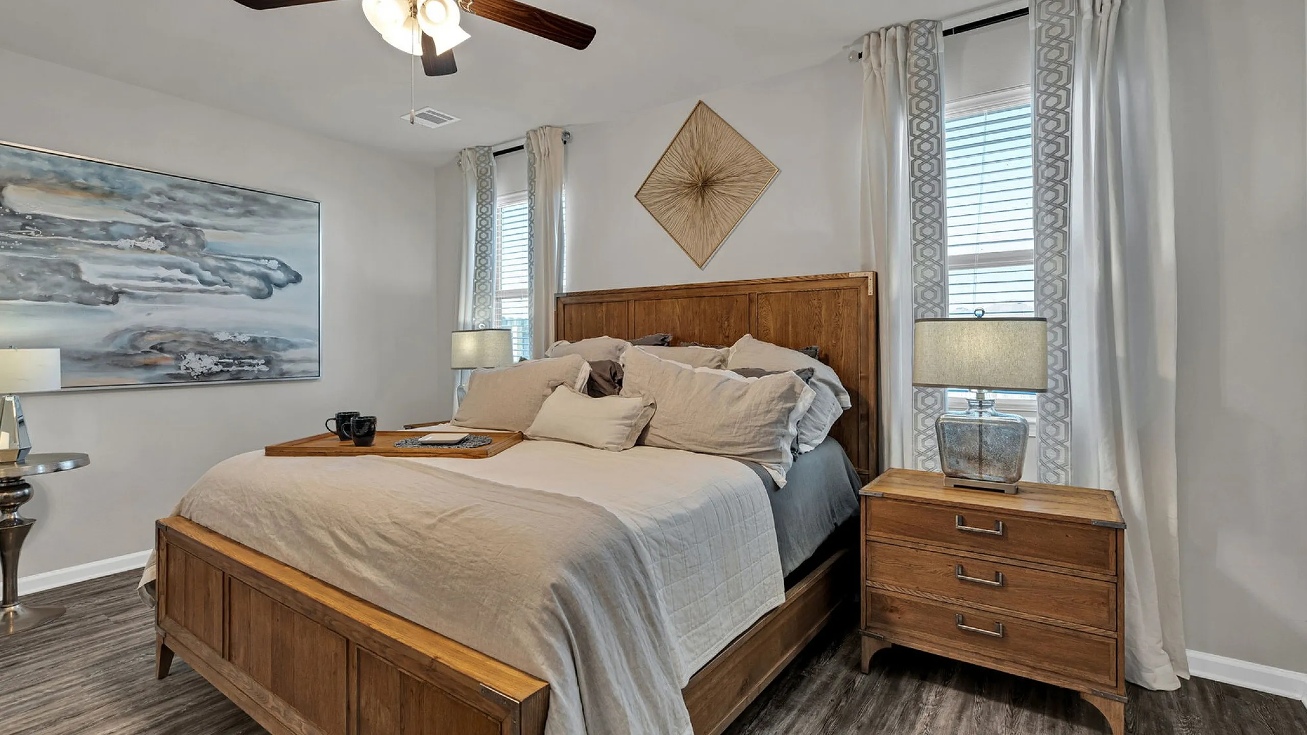 Cullen floorplan, 3 bedroom primary bedroom furnished with bedding, curtains, lamps, view of backyard