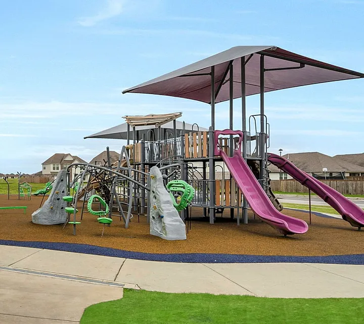 Playground with sun covers, covered picnic table pavilion area, climbing playground, swings, etc.