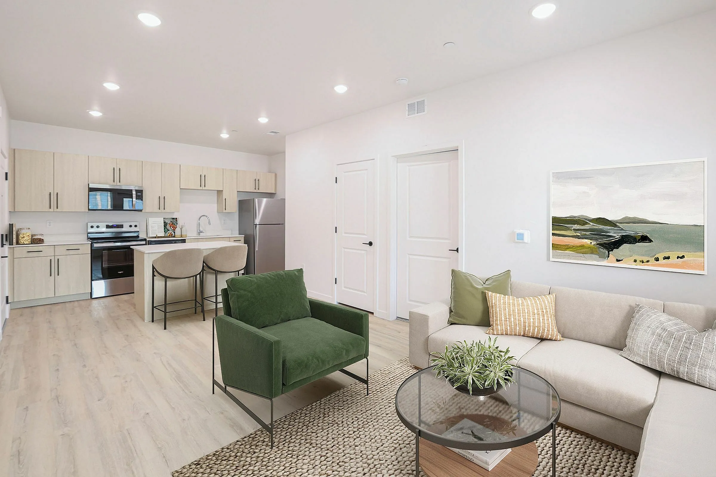 Modern open-concept apartment with a sleek kitchen, stylish furnishings, and inviting decor in a bright living space.