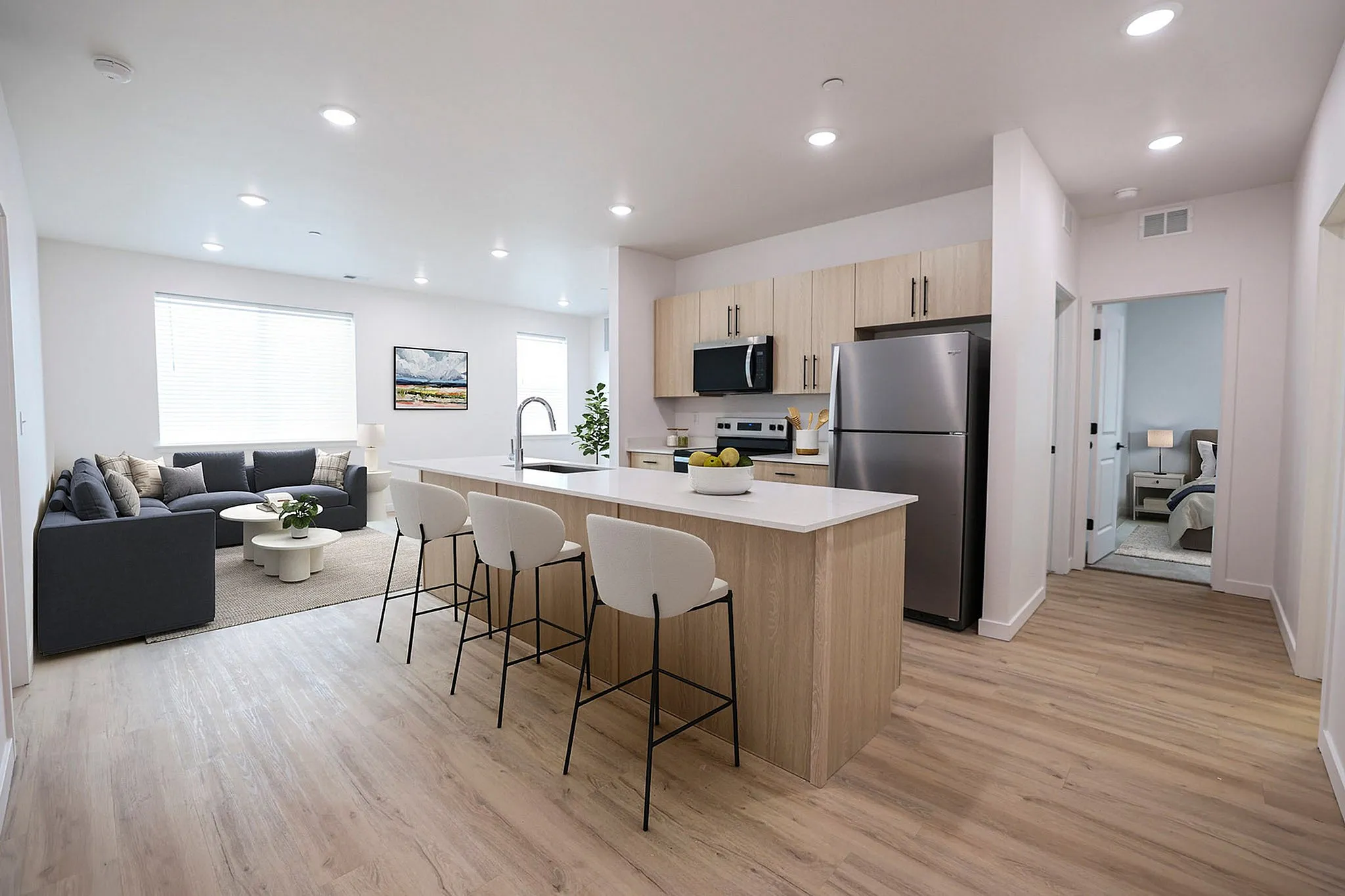 Modern open-concept kitchen and living area with sleek appliances, contemporary furniture, and inviting natural light.