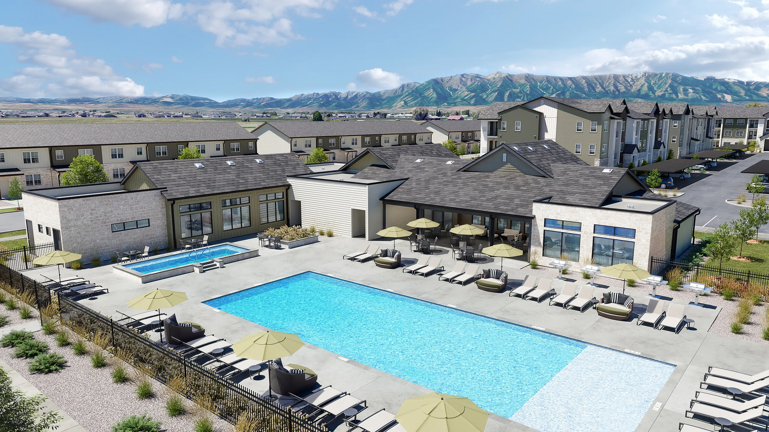 Luxurious apartment complex featuring a large sparkling pool, relaxing sun loungers, and scenic mountain views for an upscale lifestyle.