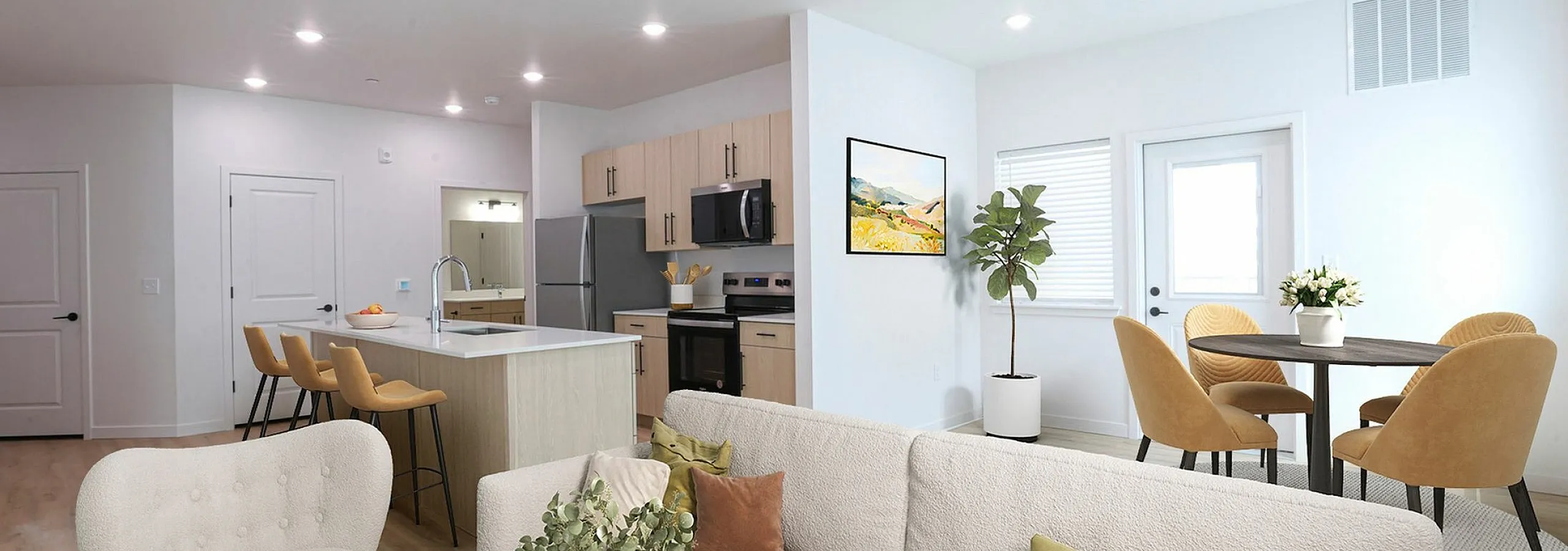 Bright and modern open-concept living area with sleek kitchen, cozy lounge, and elegant dining space.