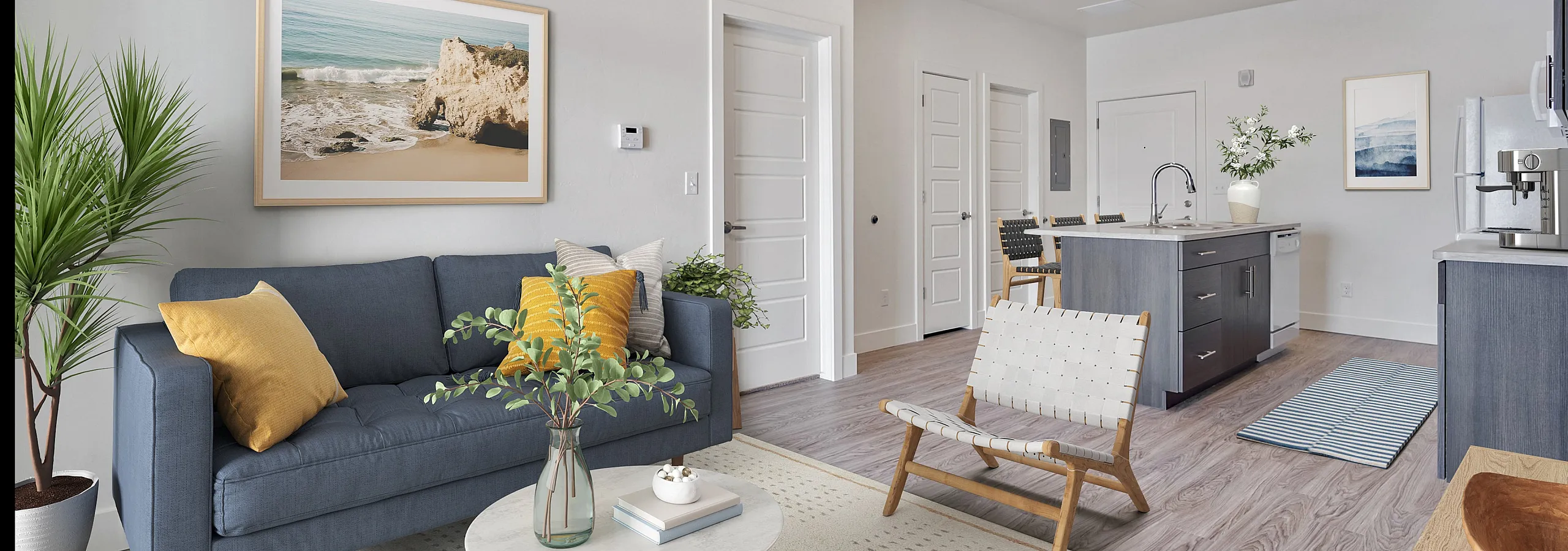 Chic open-concept apartment living room with stylish decor, modern kitchen island, and inviting seating area.