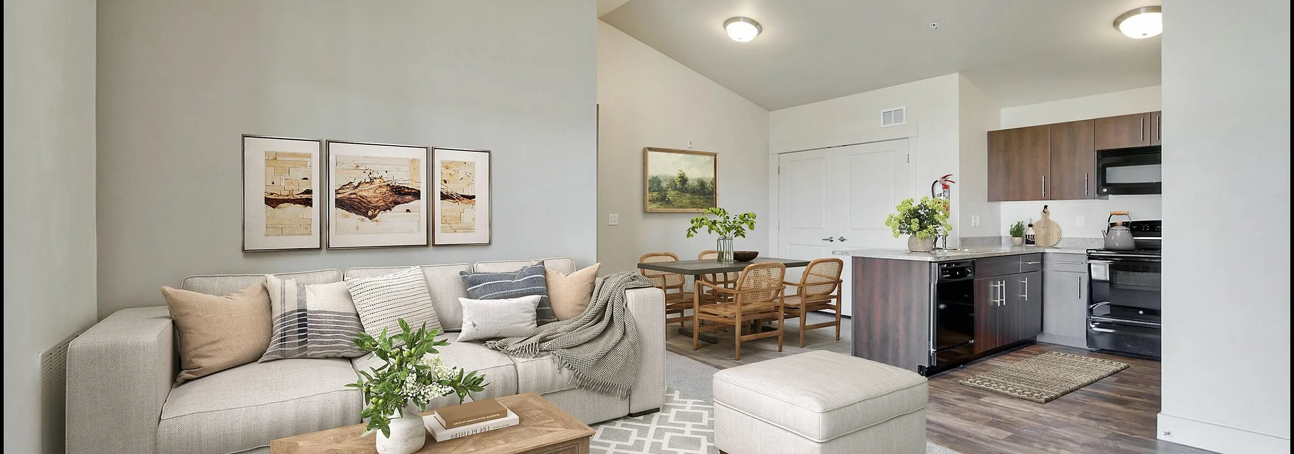 Inviting open-concept living space with a cozy sectional, elegant dining area, and modern kitchen; perfect for contemporary living.