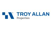Modern Troy Allan Properties logo featuring a sleek blue geometric design and bold lettering, symbolizing trust and innovation in real estate.