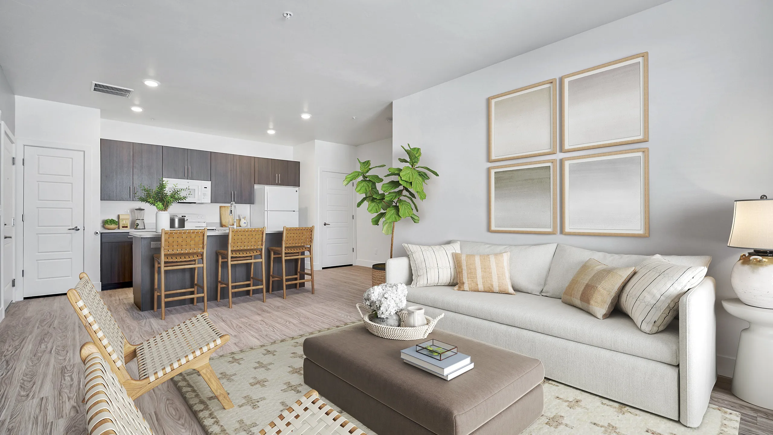 Inviting open-concept living area with modern kitchen, cozy sofa, chic decor, and natural light.