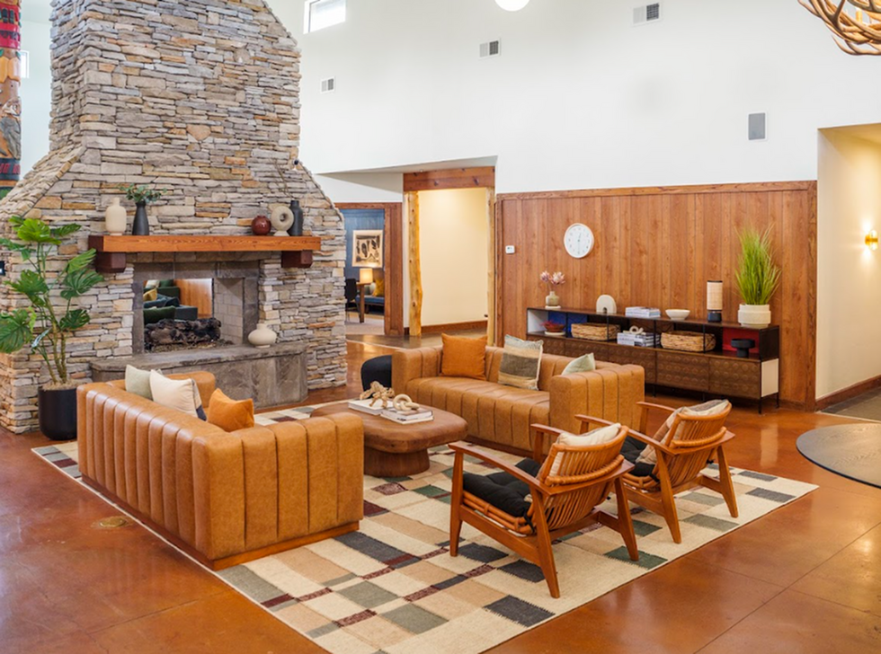 Resident clubhouse lounge with fireplace and seating at The Lodge of Athens