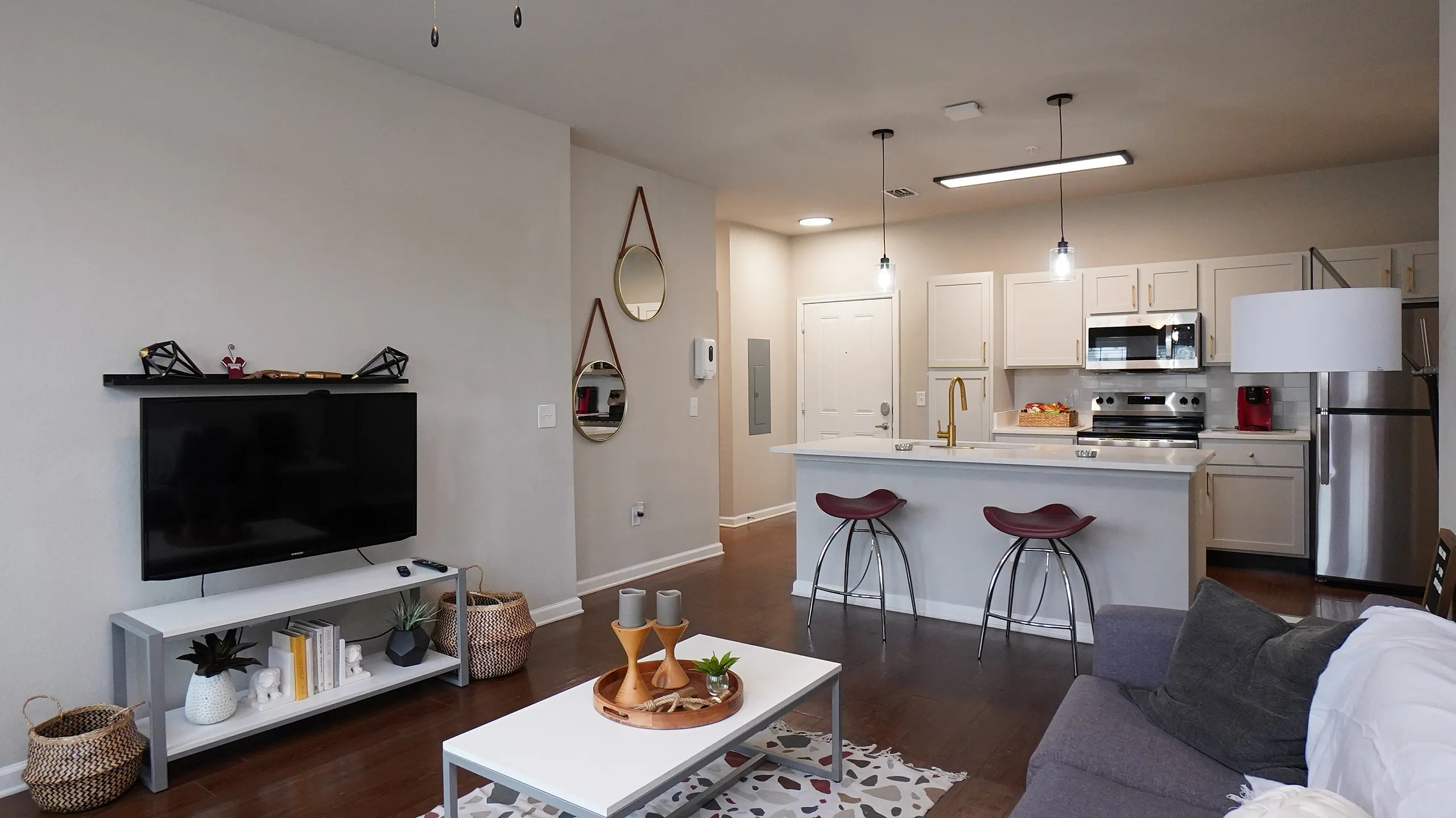 Modern open-concept living room with elegant kitchen, cozy seating area, and stylish decor.
