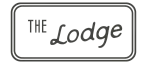 Elegant sign reading 'The Lodge' in a modern, stylish font.