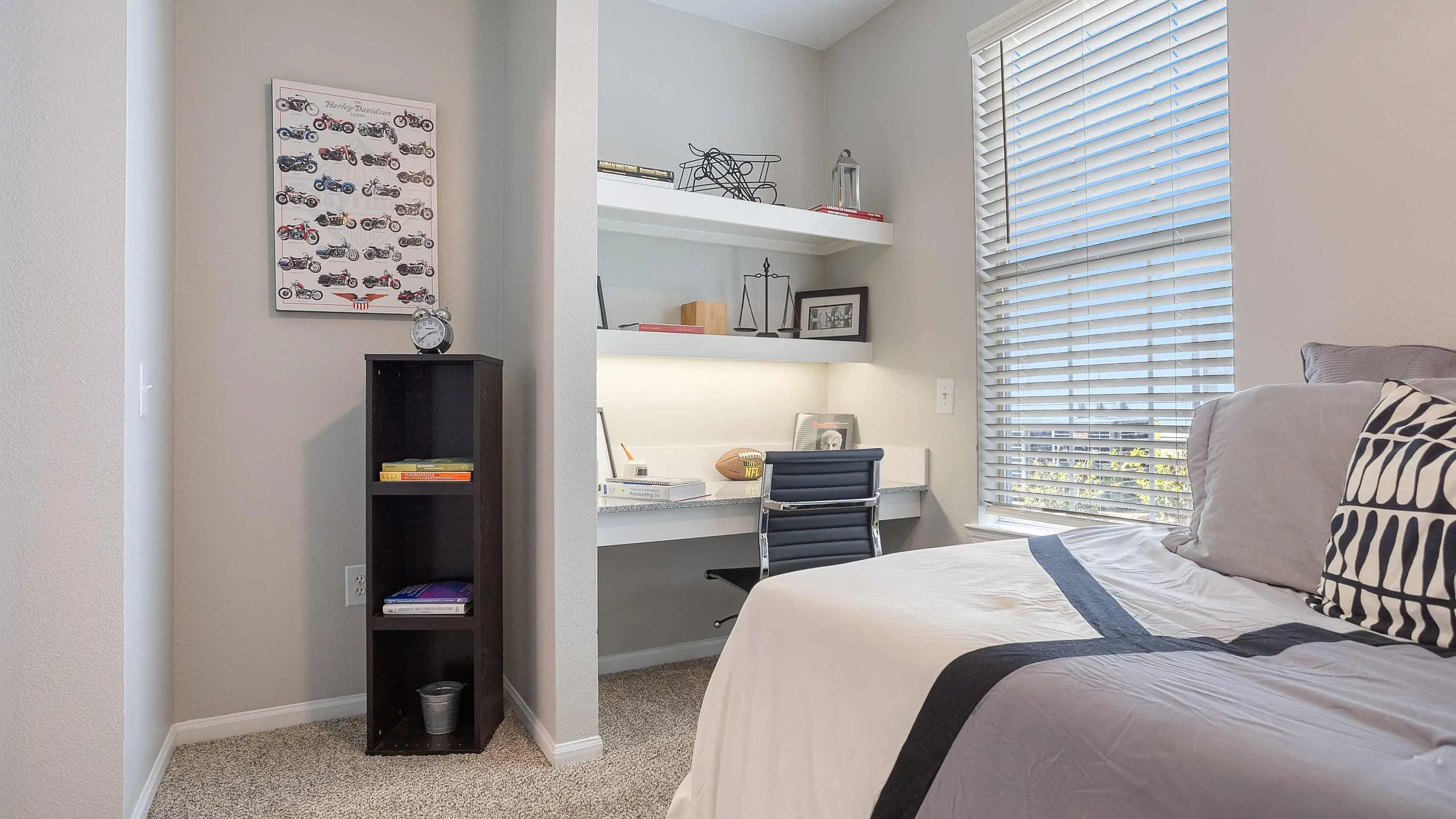 Bright and modern bedroom with a cozy study nook, featuring a sleek desk, comfortable chair, and ample natural light.