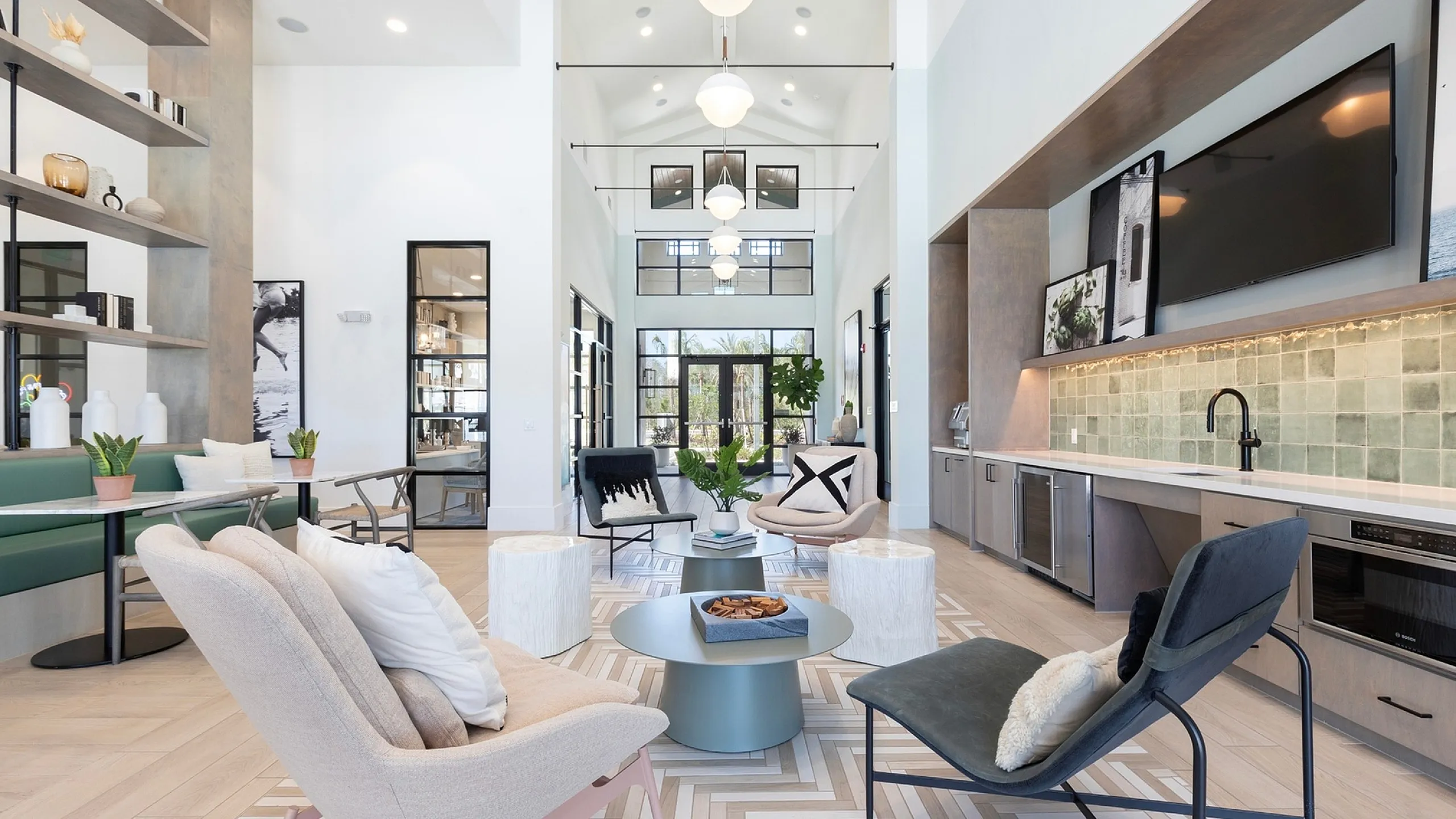 Luxurious open-concept living area with modern furnishings, elegant lighting, and stylish kitchen amenities.