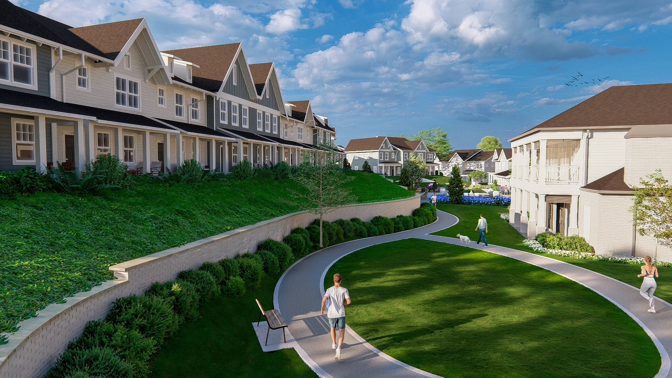 Charming townhouse community with lush green lawns, walking paths, and stylish architecture under a bright blue sky.
