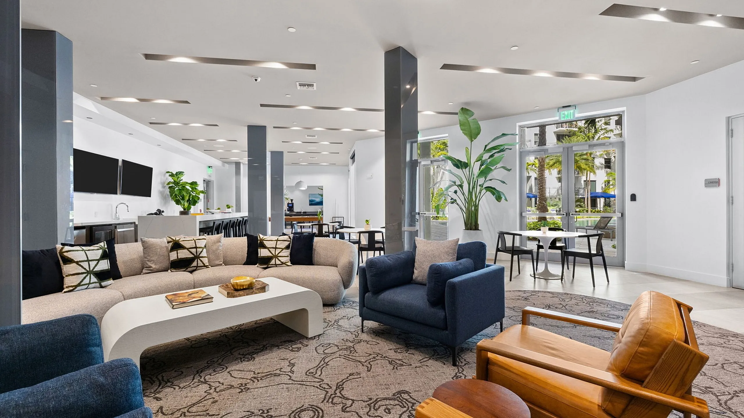 Luxurious and spacious lounge area featuring modern sofas, elegant lighting, and vibrant greenery, perfect for relaxation and social gatherings.