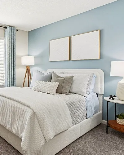 Bright and cozy bedroom with a plush bed, elegant decor, and soft lighting, perfect for relaxation.