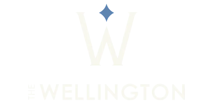 Elegant Wellington logo featuring a stylized W with a blue diamond above, embodying sophistication and luxury.